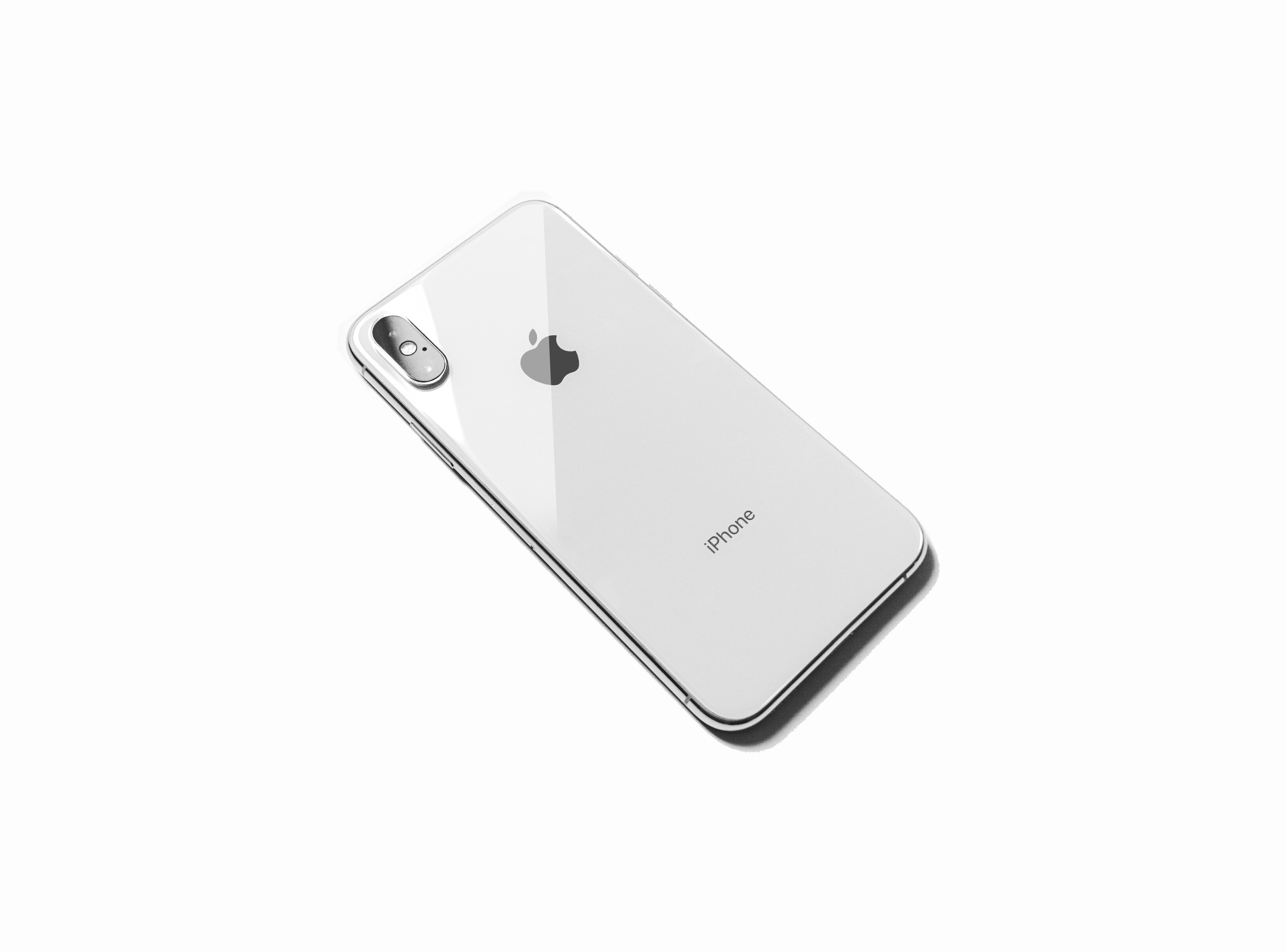 Back of a white Apple iPhone on a light background for the Apple Exchange Program.
