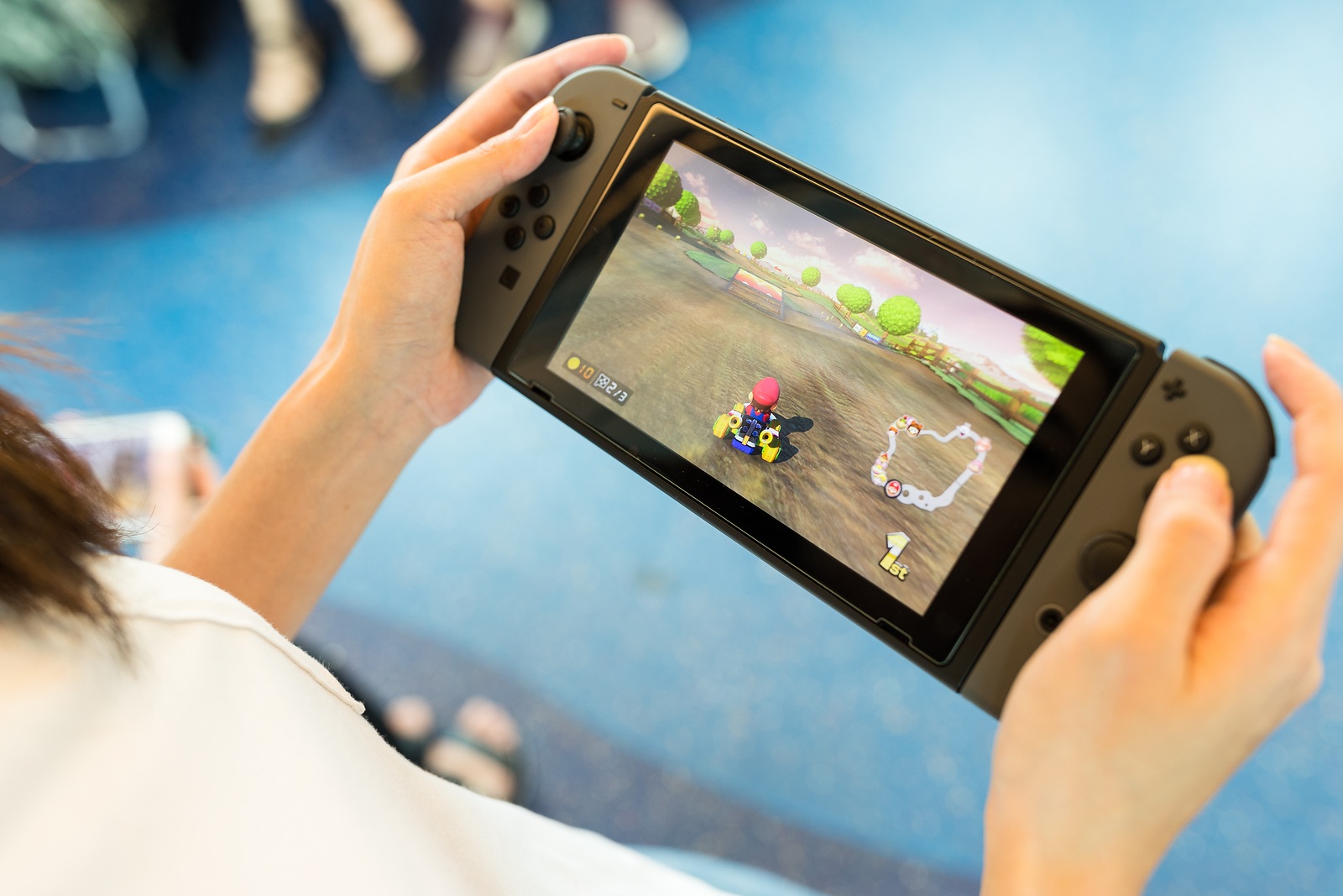Hong Kong, May 19, 2017 -:Woman holding a Nintendo Switch with playing Mario Kart 8