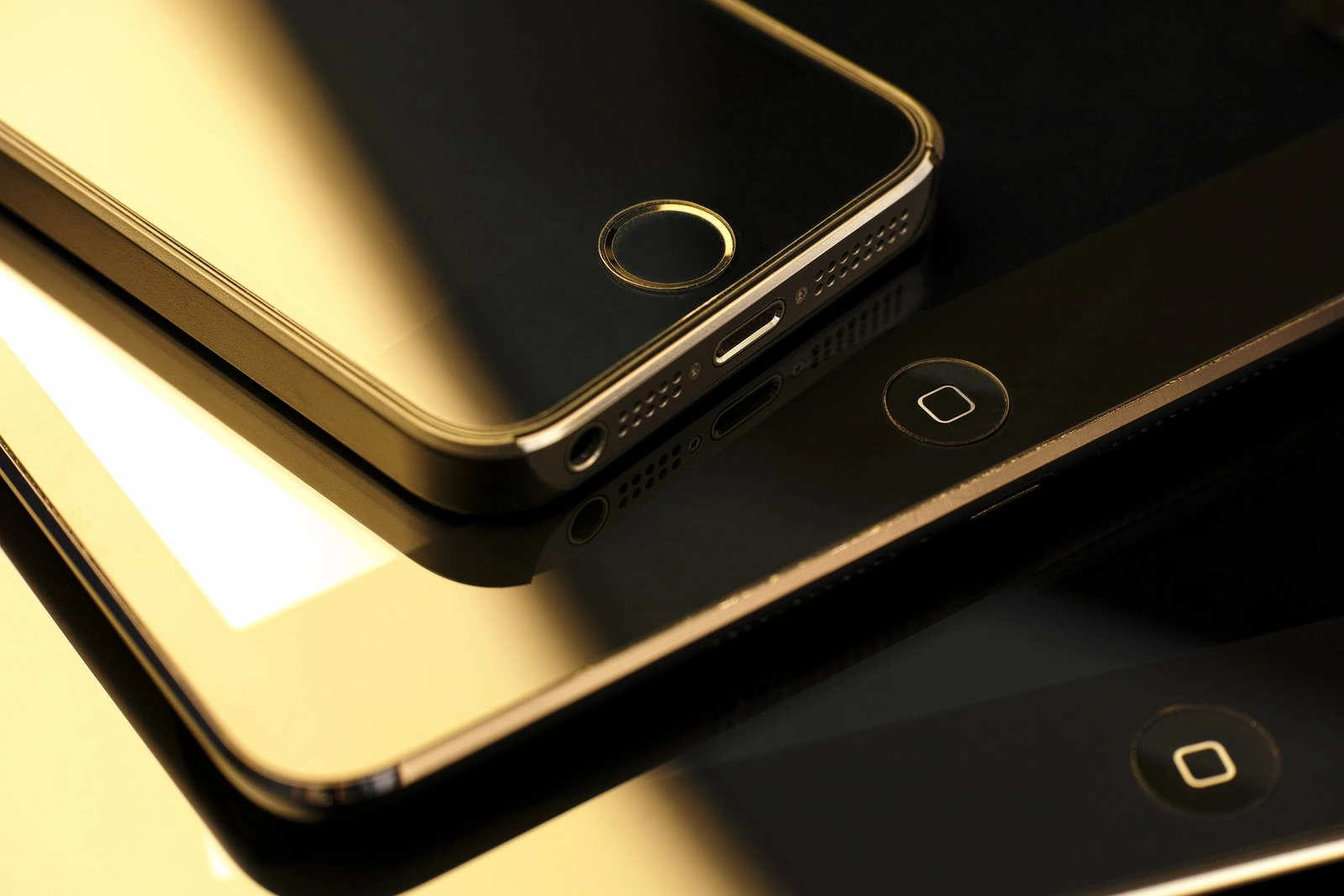 Tambov, Russian Federation - February 26, 2015 Close up of stack of Apple devices - iPhone 5s, iPad mini and iPad 2. Studio shot.
