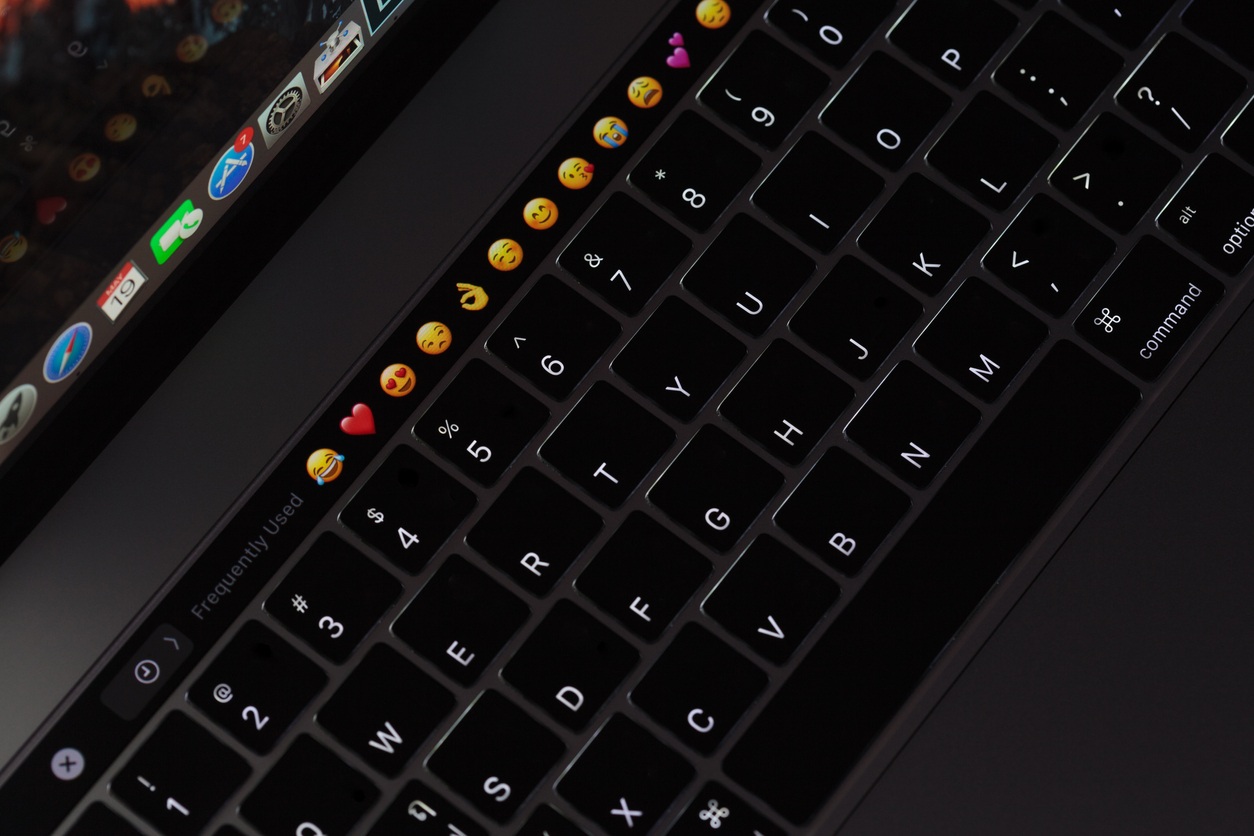 Bangkok, Thailand - May 19, 2017: Closeup new MacBook Pro 2016 keyboard showing illuminated and emoji on touch bar, MacBook Pro manufactured by Apple Inc.