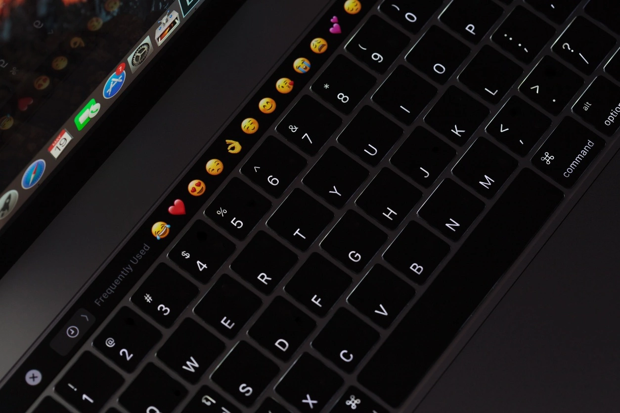 Bangkok, Thailand - May 19, 2017: Closeup new MacBook Pro 2016 keyboard showing illuminated and emoji on touch bar, MacBook Pro manufactured by Apple Inc.