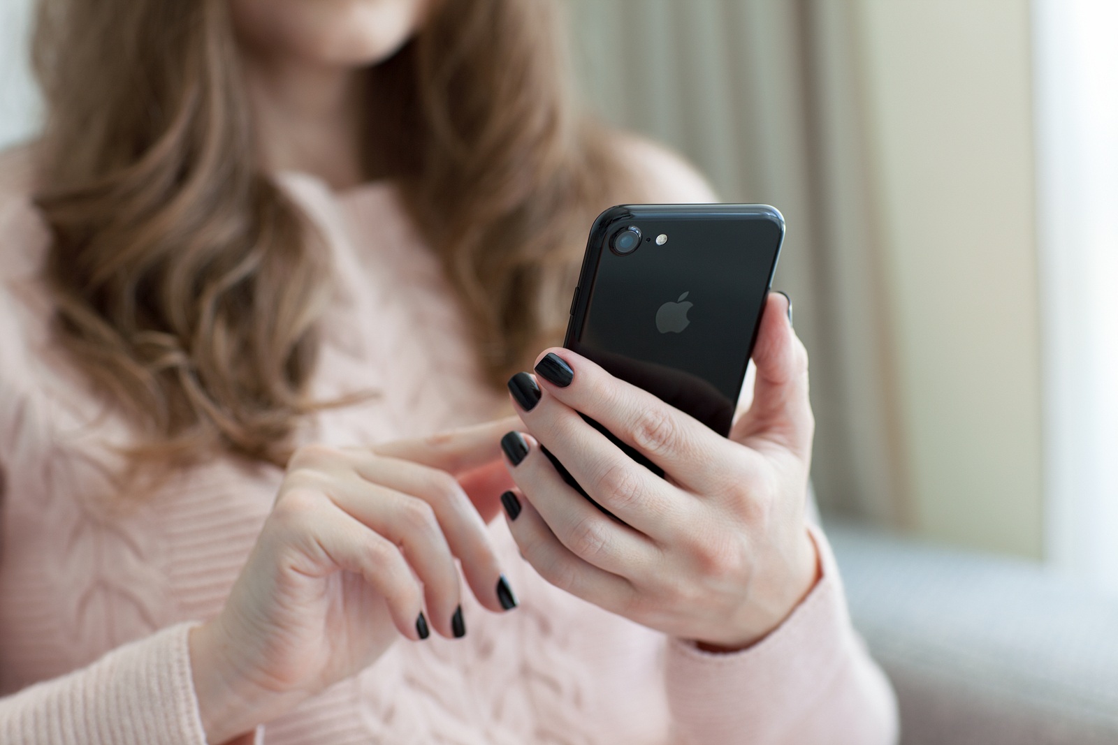 Alushta Russia - October 28 2016: Woman holding in the hand a new iPhone 7. iPhone 7 Jet Black was created and developed by the Apple inc.