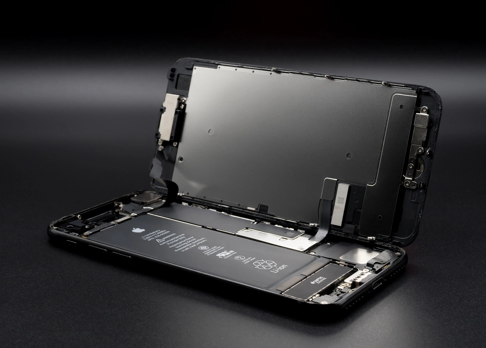 Chiangrai Thailand: May 19 2017 - Apple iPhone 7 jet black color disassembled for repair and showing components inside on black background. Selective focus