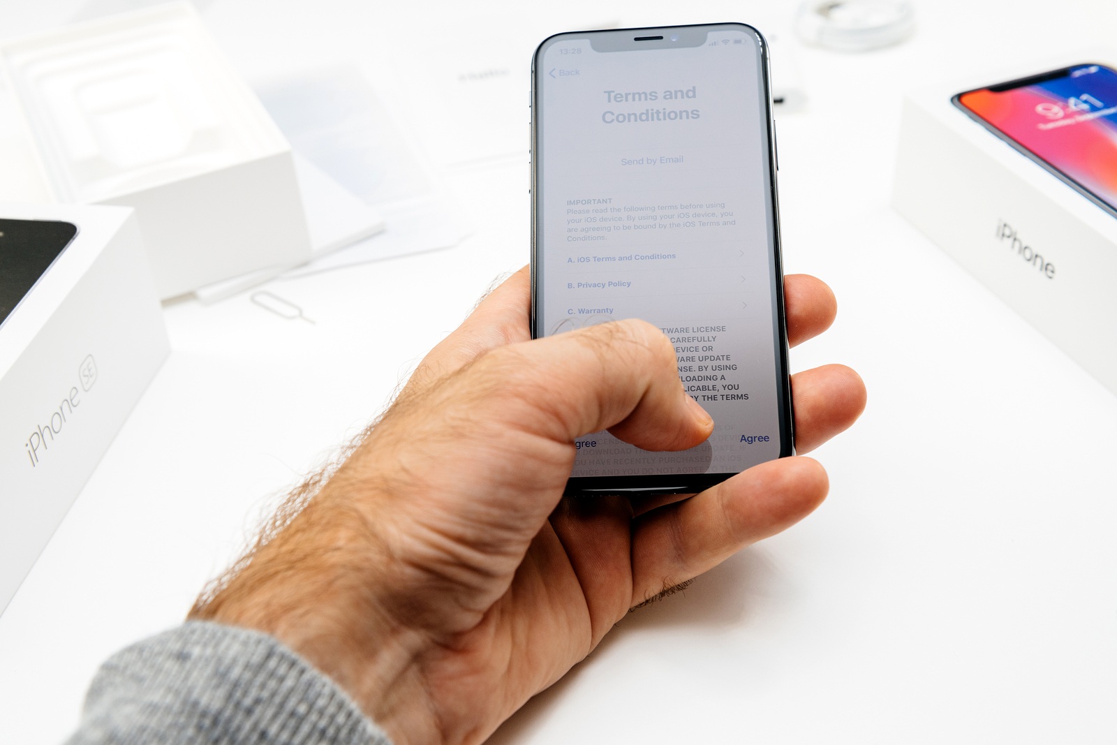 PARIS FRANCE - NOV 3 2017: New Apple iPhone X 10 smartphone first run with hand accepting Terms and Conditions of Privacy and warranty