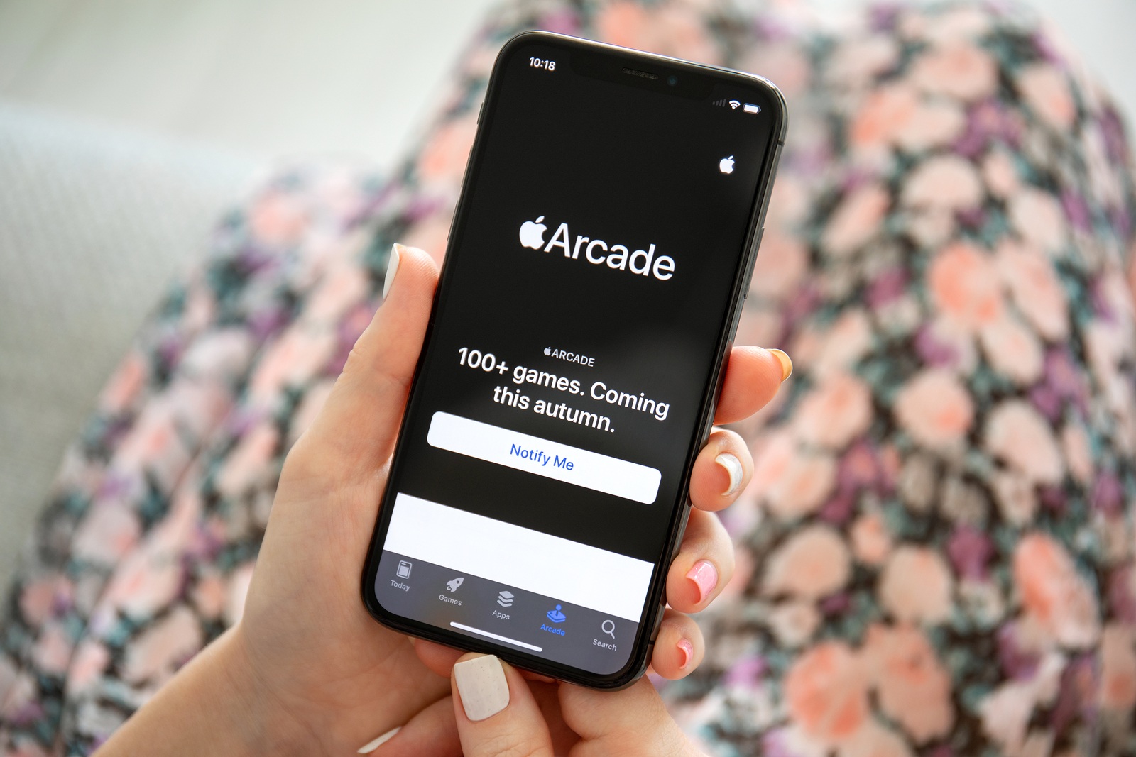 Anapa, Russia - July 25, 2019: Woman holding iPhone X with Game service Apple Arcade on the screen. iPhone ten was created and developed by the Apple inc.