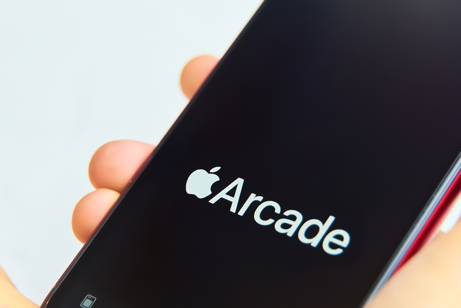 Bishkek, Kyrgyzstan - June 05, 2019: New Apple Arcade logotype on modern iPhone featuring new subscription model for over 100 groundbreaking new games