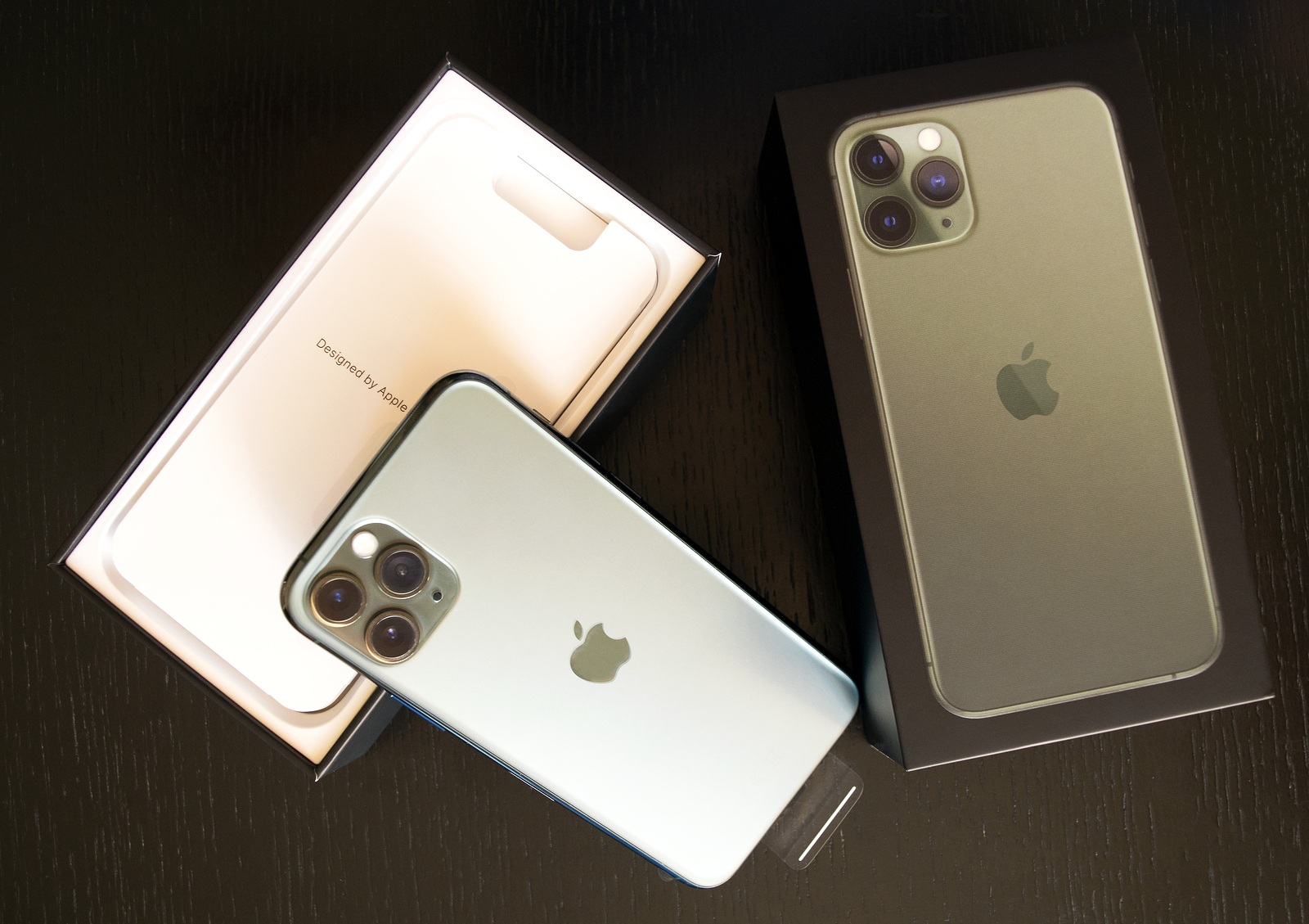 Dubai / UAE - September 21, 2019: New Midnight Green Apple iPhone 11 Pro in original box isolated on dark wooden background. iphone 11 pro