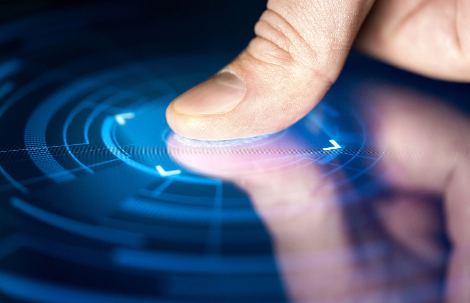 Fingerprint recognition technology for digital biometric cyber security and identification. Finger print scan for authentication, security and privacy. Thumb on electronic smart screen (macro).