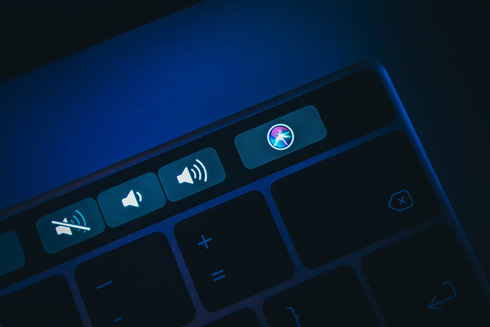 France, Paris - June 25, 2018: New Siri icon application button on the Touch Bar of macbook keyboard, close-up.