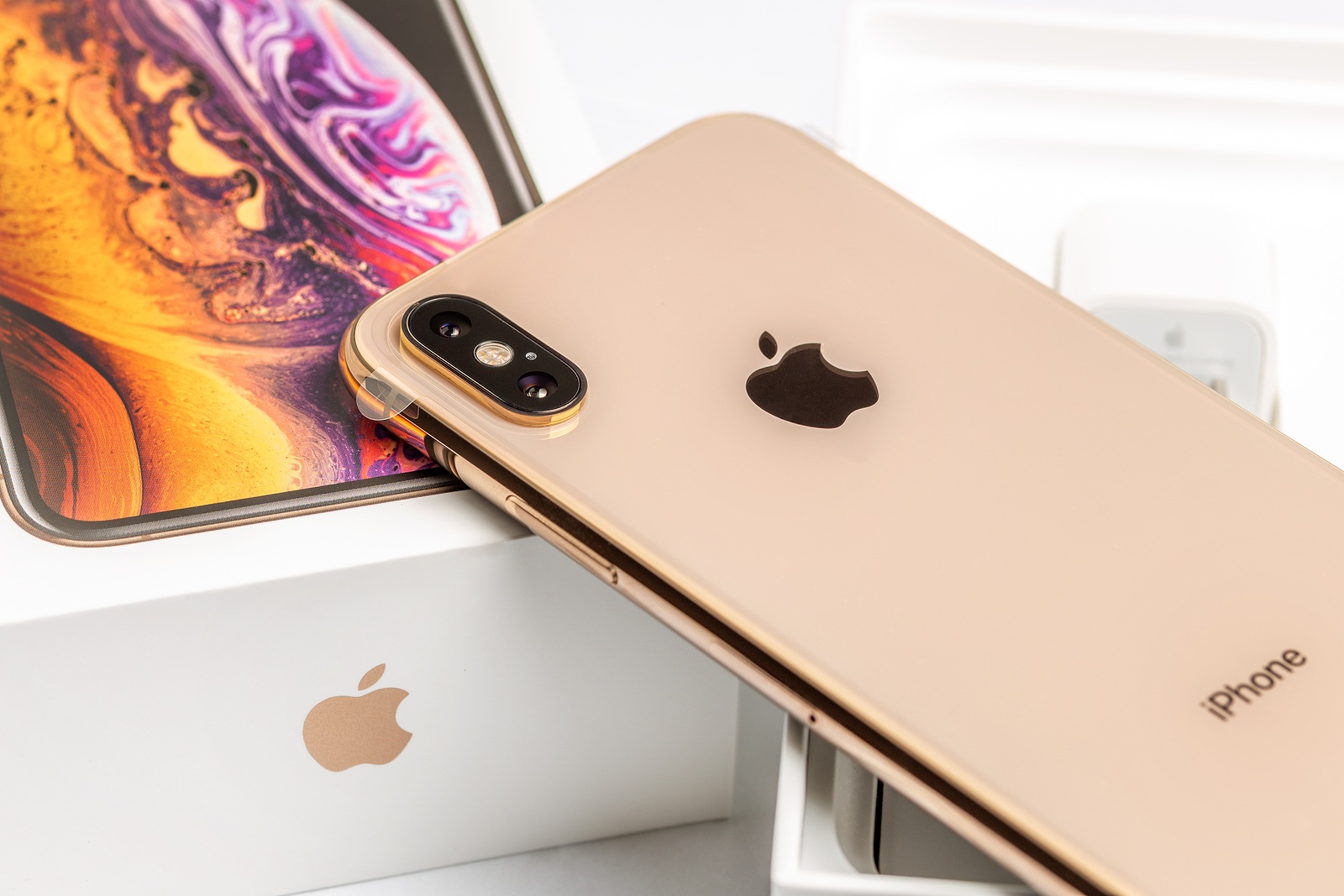 12th October, 2018-Kiev, Ukraine: Latest iPhone XS on opened box on white table. Newest Apple smartphone on white branded box in mobile store. Modern gadget with dual camera and OLED screen for sale