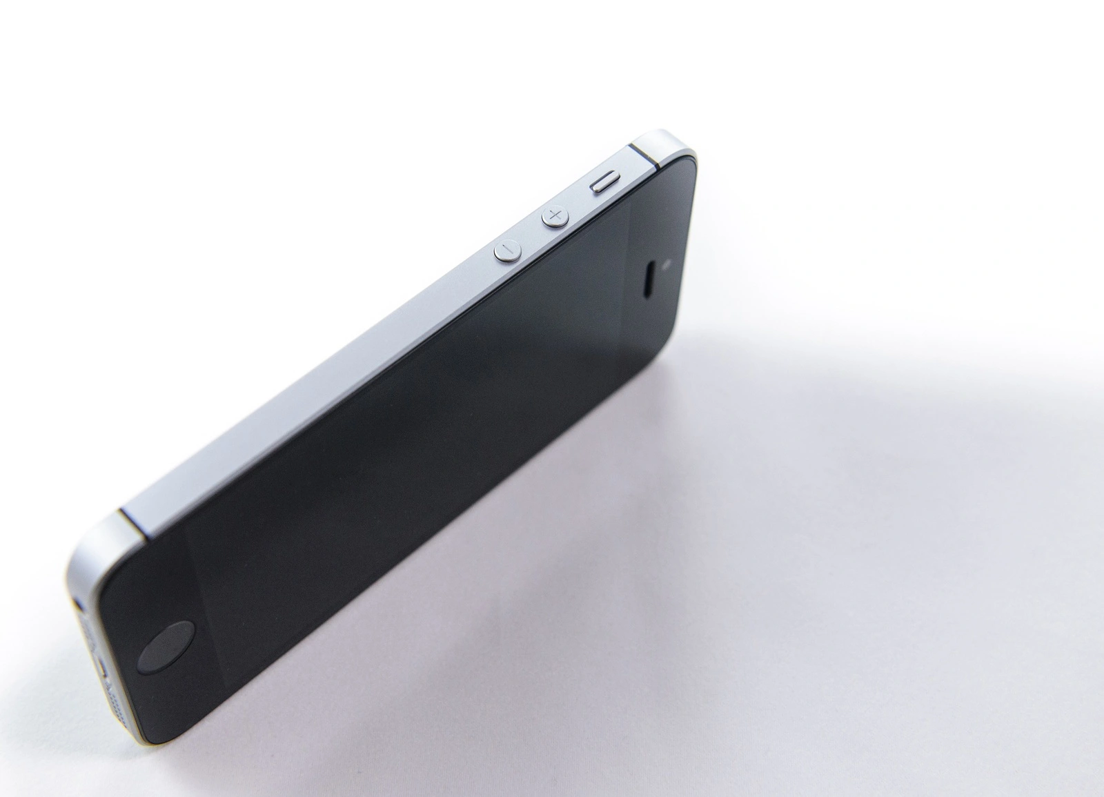 PARIS FRANCE - APR 21 2016: Side view of the new Apple iPhone SE combining the updated processor 4K rear camera touch id retina display