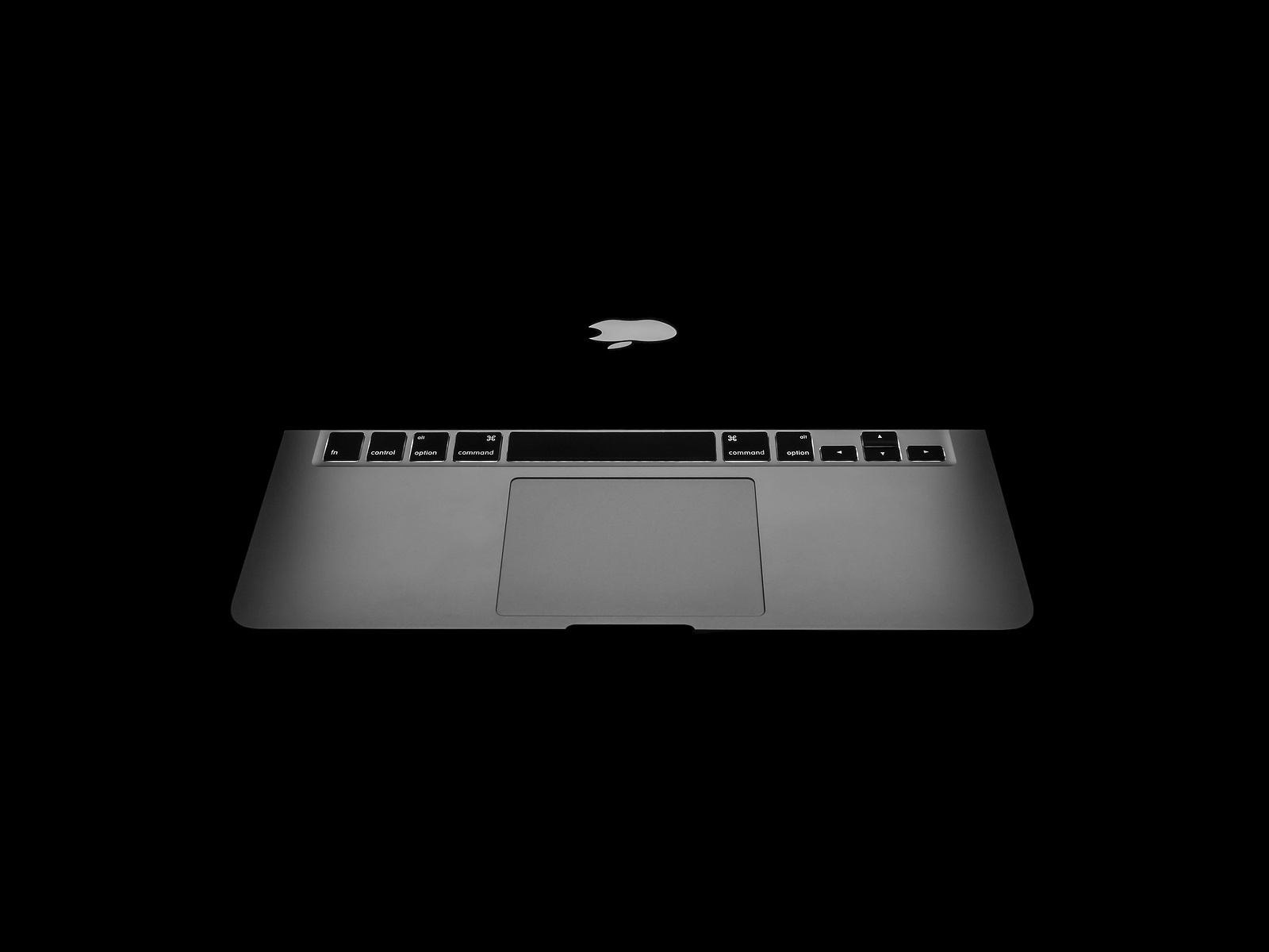 CHIANGRAI THAILAND -OCTOBER 19 2016: New Macbook Pro with Retina display showing backlight of Apple's logo and keyboard in dark. MacBook is a brand of notebook computers manufactured by Apple Inc.
