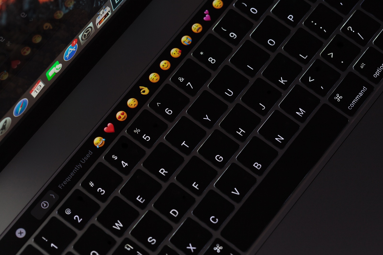 Bangkok Thailand - May 19 2017: Closeup new MacBook Pro 2016 keyboard showing illuminated and emoji on touch bar MacBook Pro manufactured by Apple Inc.