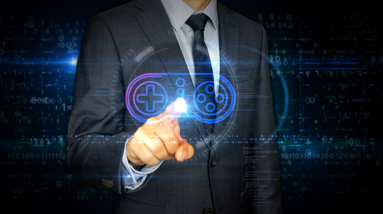 A businessman in a suit touch screen with game pad symbol hologram. Man using hand on virtual display interface. Gaming, 5G, play and online game futuristic concept.