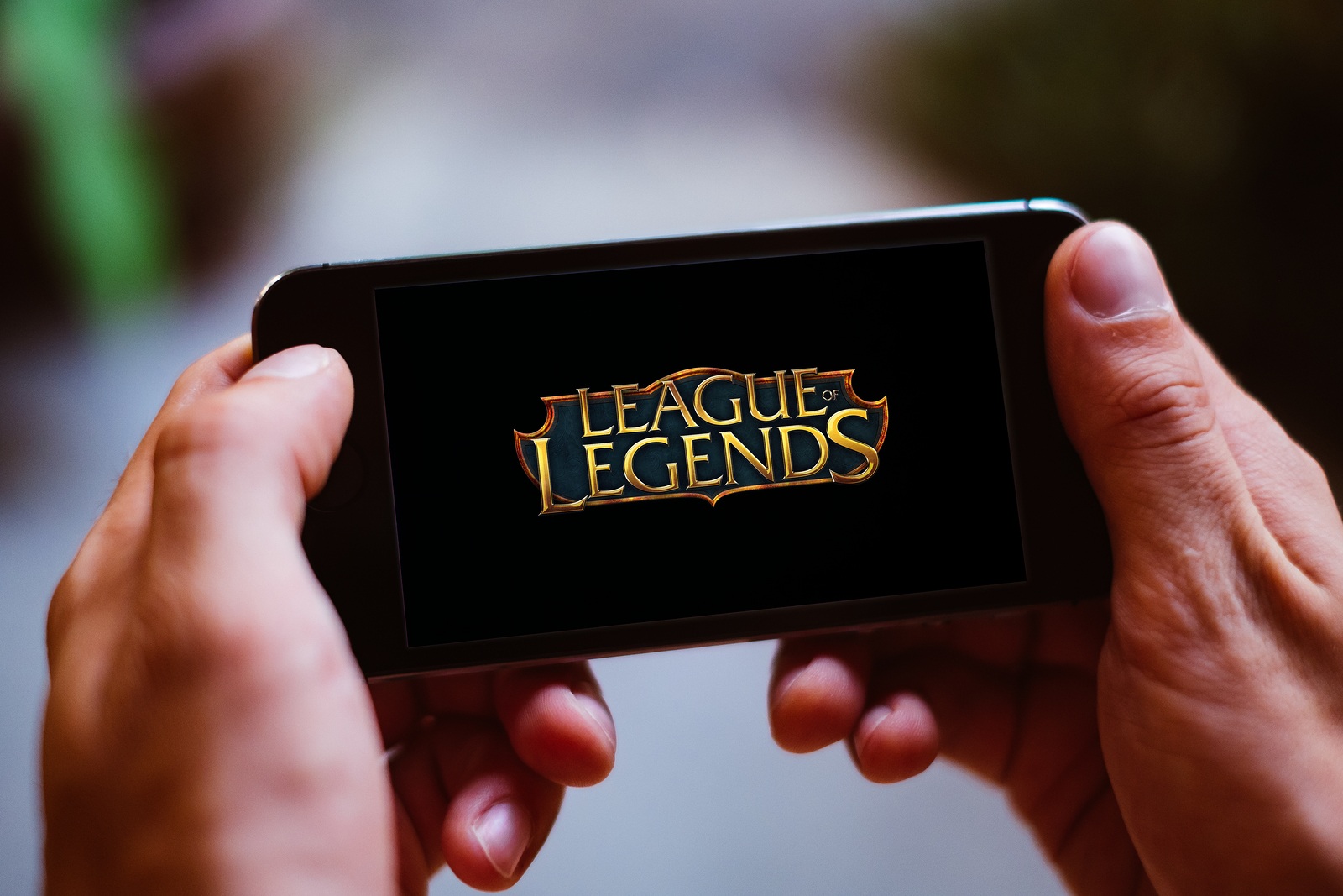 BERLIN, GERMANY - AUGUST 26, 2018: Closeup of smartphone screen with LEAGUE OF LEGENDS GAME LOGO and ICON