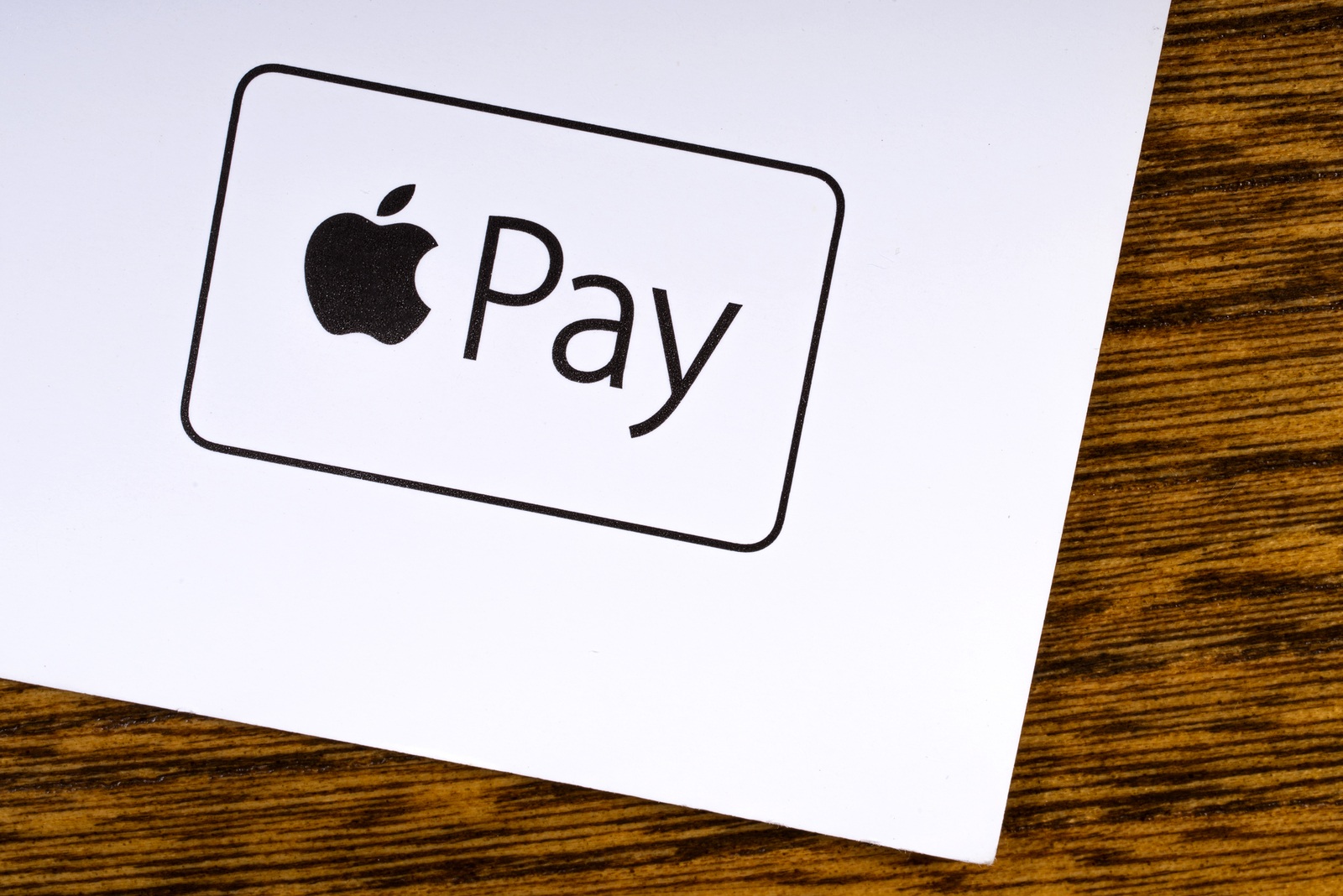 LONDON, UK - MARCH 27TH 2018: A close-up of the Apple Pay logo, pictured on the bottom of a leaflet, on March 27th 2018. Apple Pay is a mobile payment and digital wallet service by Apple Inc.
