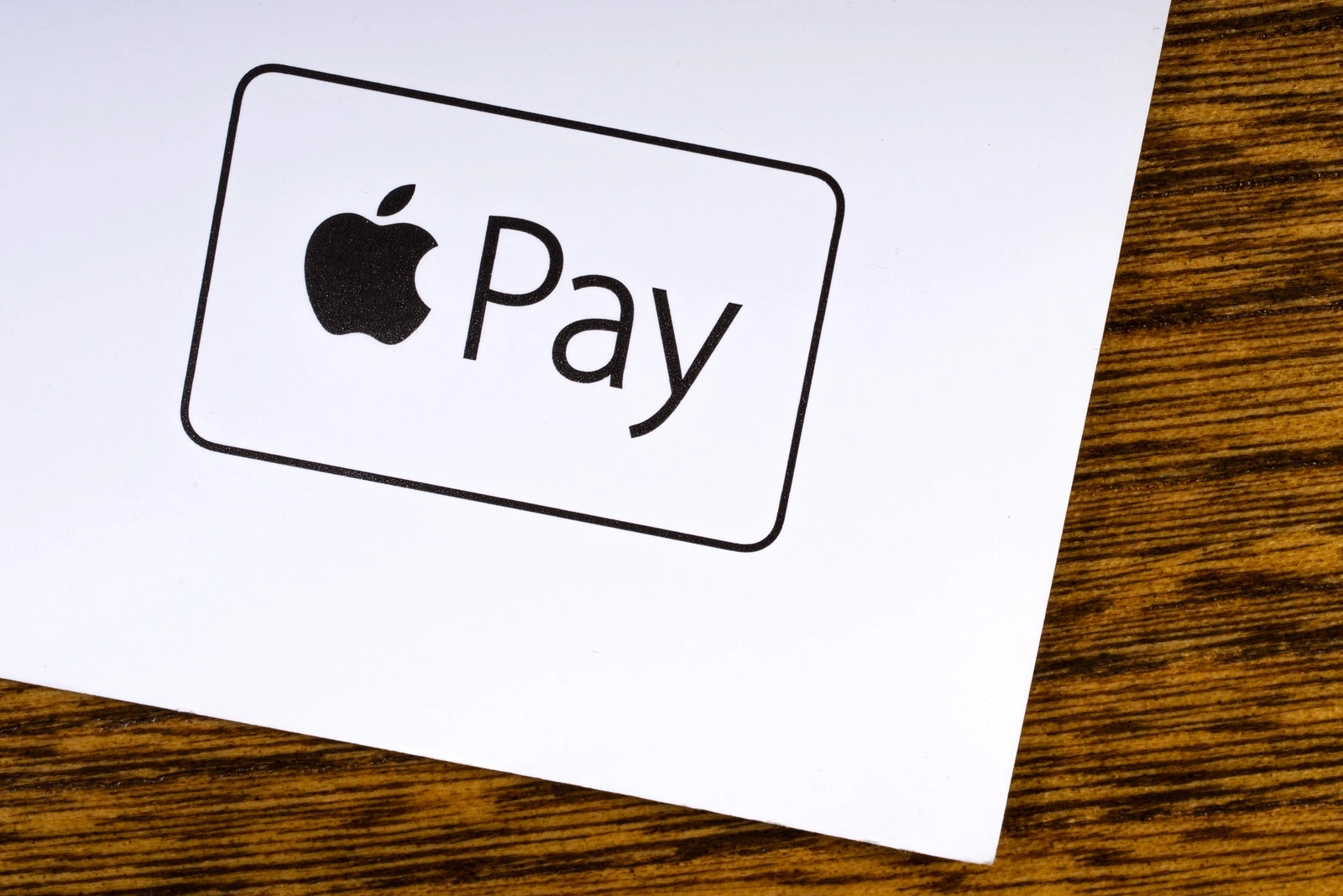 LONDON, UK - MARCH 27TH 2018: A close-up of the Apple Pay logo, pictured on the bottom of a leaflet, on March 27th 2018. Apple Pay is a mobile payment and digital wallet service by Apple Inc.