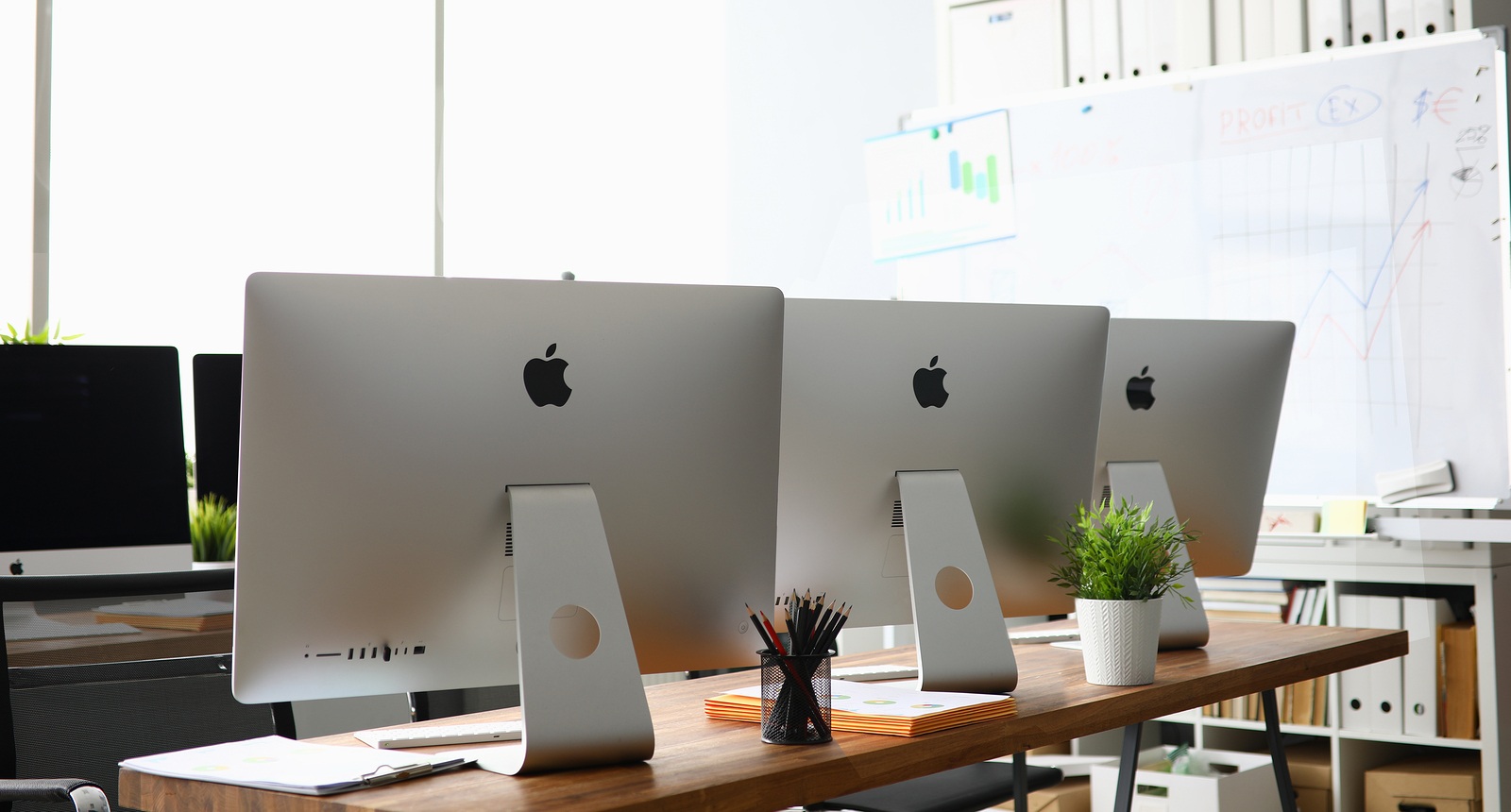 Minsk, Belarus - September 88, 2019: Many apple imac computer aganist empty office background. Illustrative editorial image.