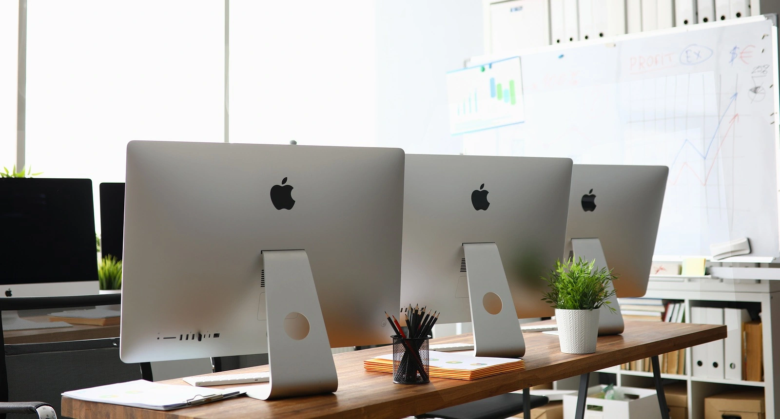 Minsk, Belarus - September 88, 2019: Many apple imac computer aganist empty office background. Illustrative editorial image.