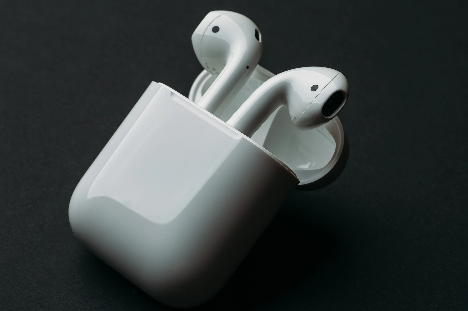 Moscow, Russia - Circa December 2018: Apple AirPods - wireless bluetooth earphones or headphones and white box for storage and charging, use with Iphone, Ipad or Mac.