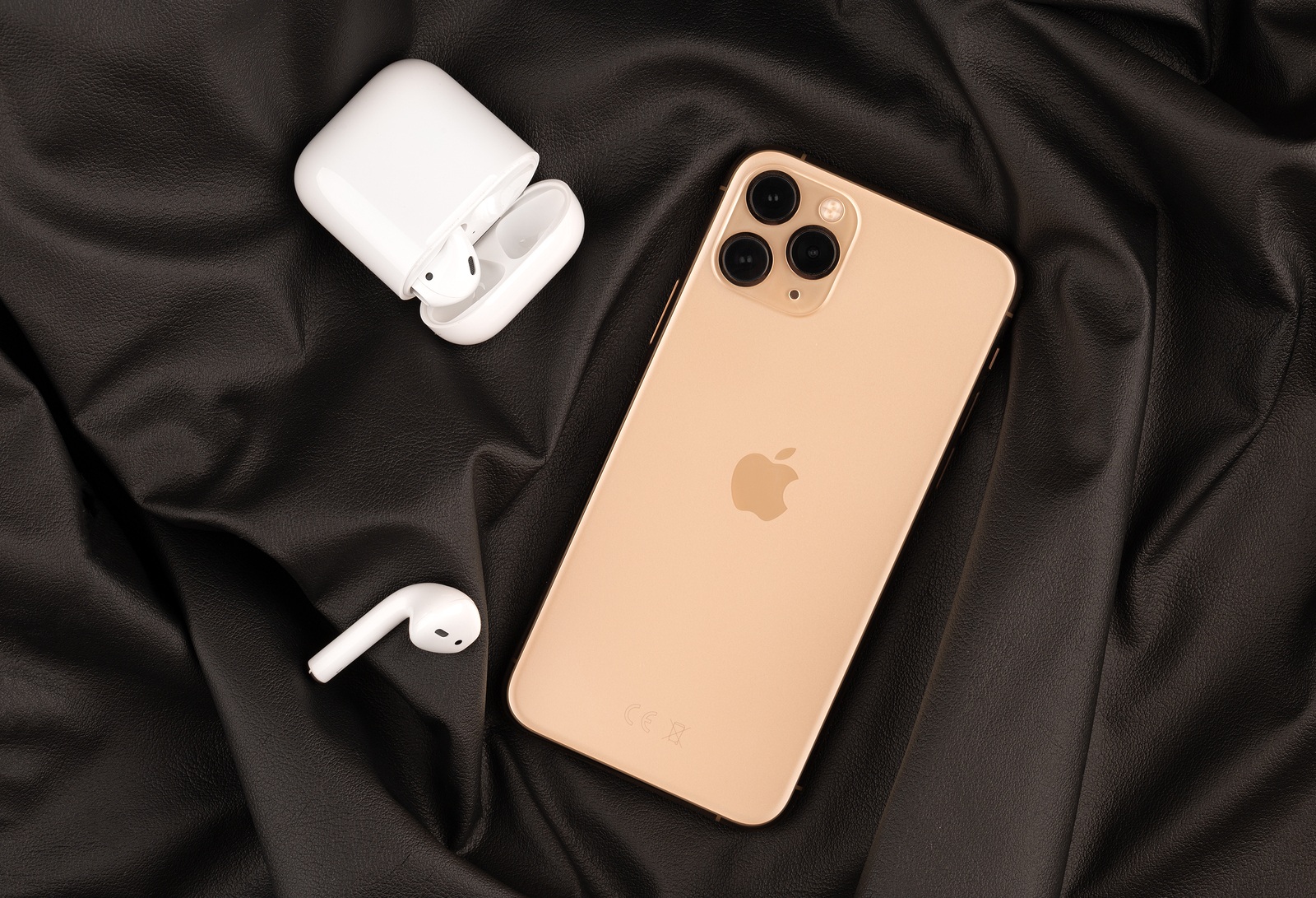 Rostov-on-Don, Russia - October 2019. Apple iPhone 11 Pro on a wooden surface. Apple's new smartphone close-up. Smartphone and AirPods headphones.