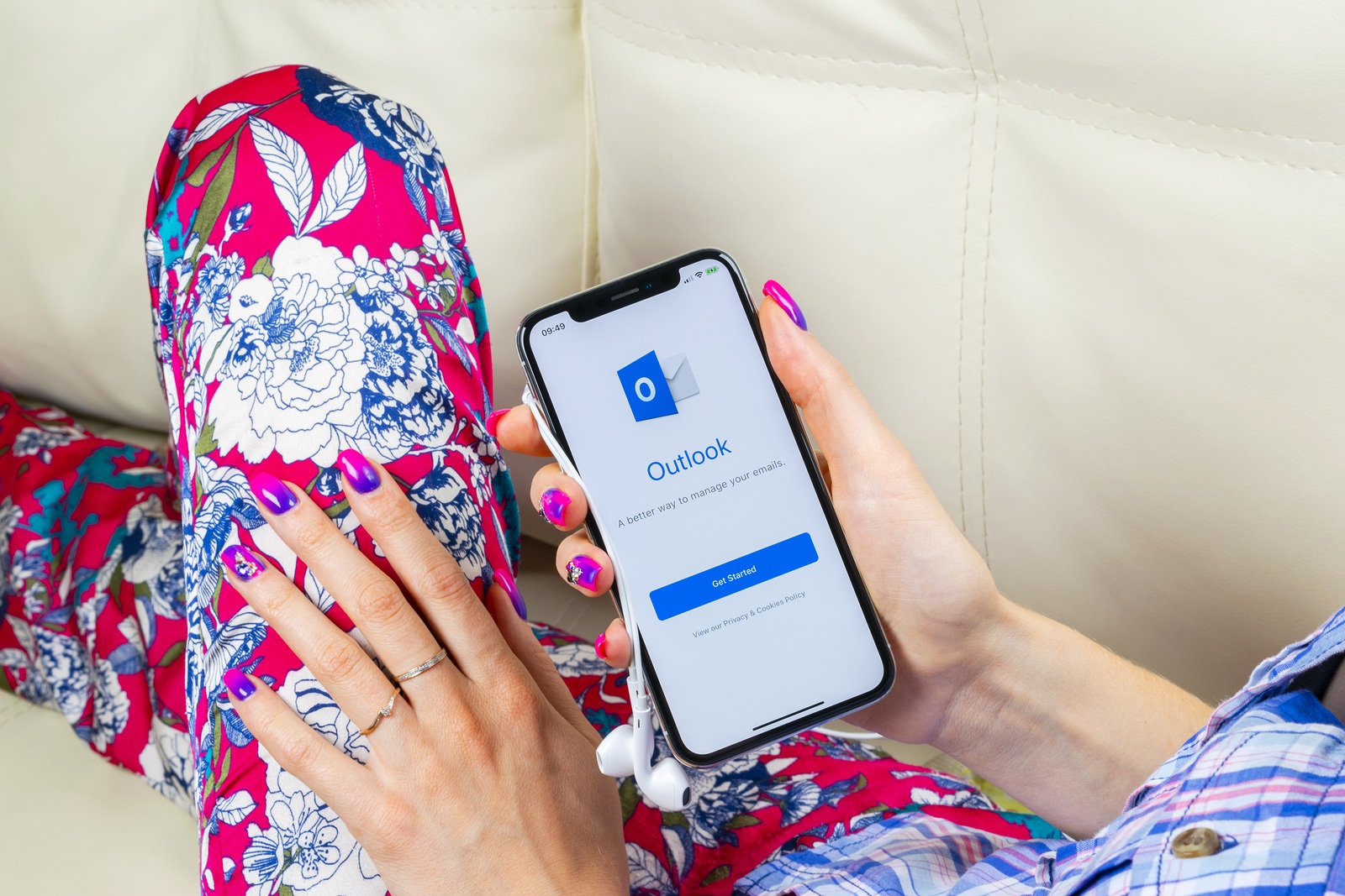 Sankt-Petersburg, Russia, June 8 2018: Microsoft Outlook office application icon on Apple iPhone X screen in woman hand. Microsoft outlook app icon. Microsoft OutLook application. Social media network