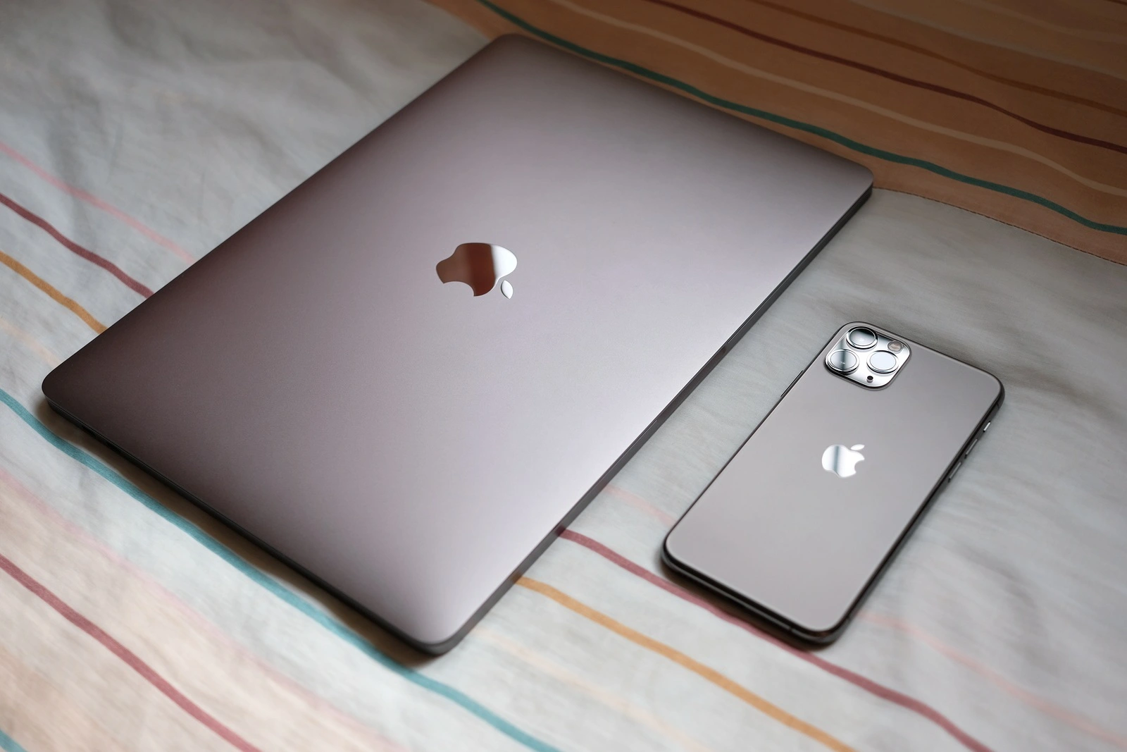 Trang, Thailand. October 25, 2019 : Customer lay down new macbook pro 2019 and iphone 11 pro are space gray colors on bed after receive from the apple store