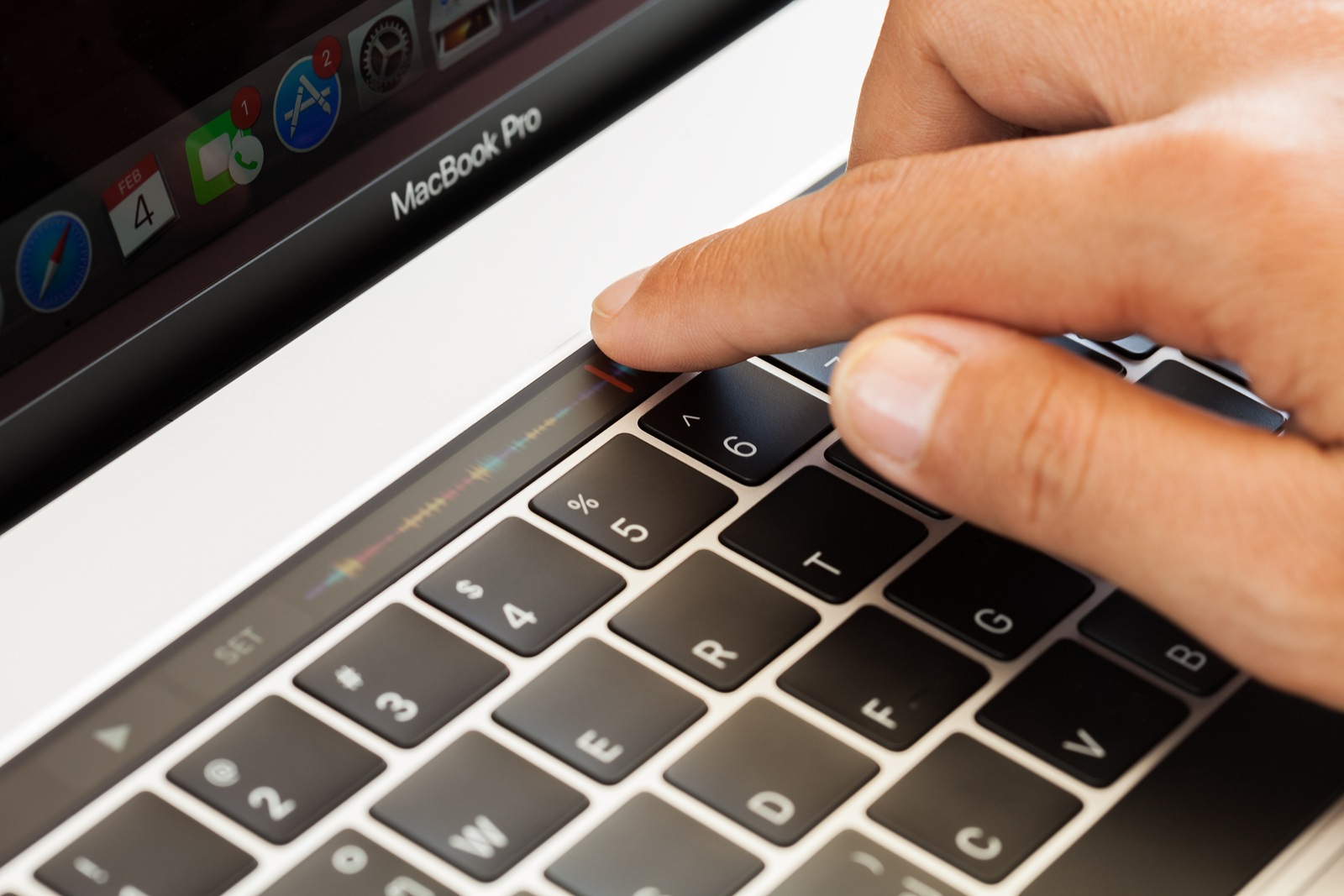 Bangkok Thailand - January 5 2017: Close-up hand touching touch bar on MacBook Pro 2016 mixing audio sound touch bar is new function on MacBook Pro 2016 by Apple Inc.