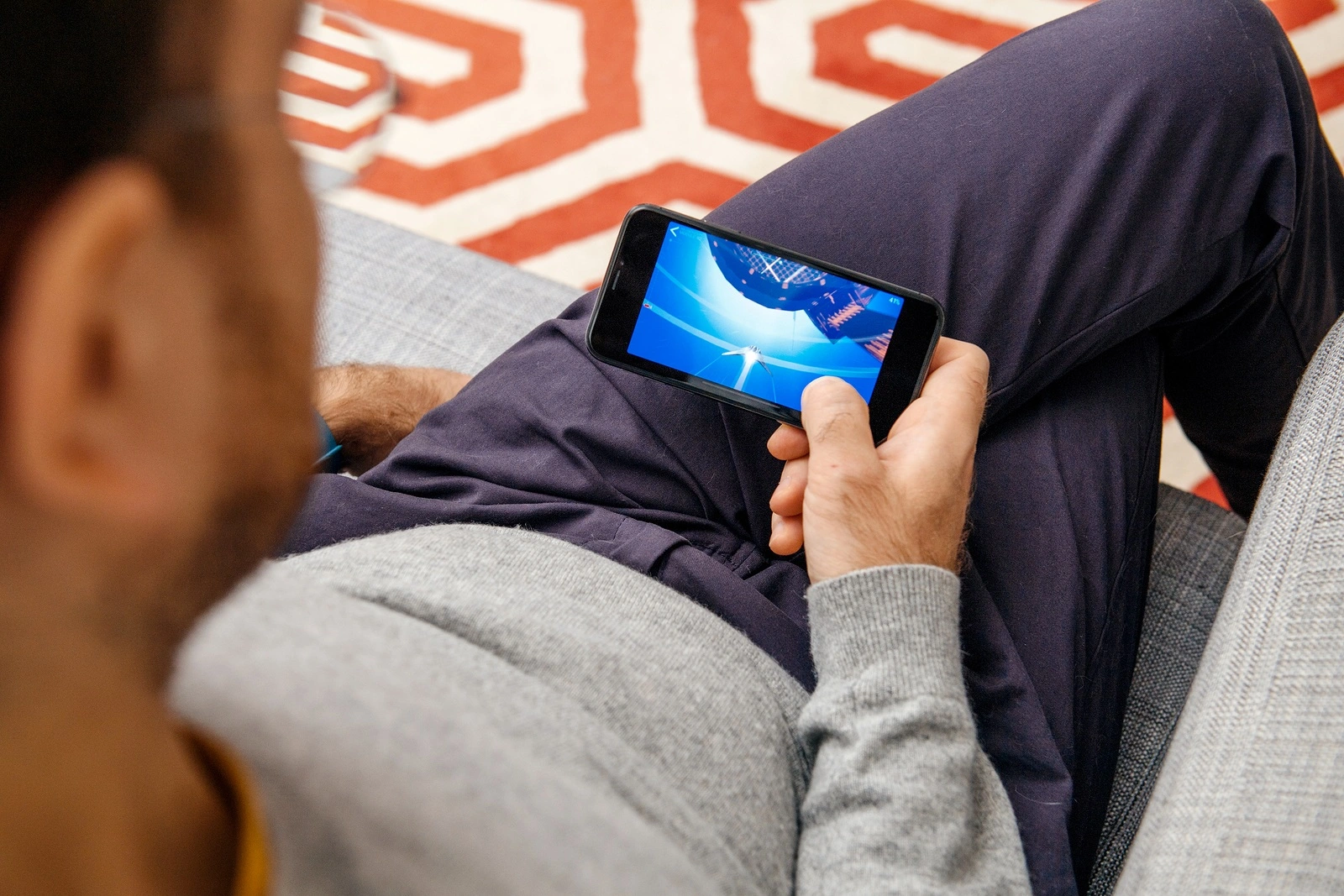 PARIS FRANCE - NOV 8 2017: Man playing arcade war game on the new Apple Computers iPhone X