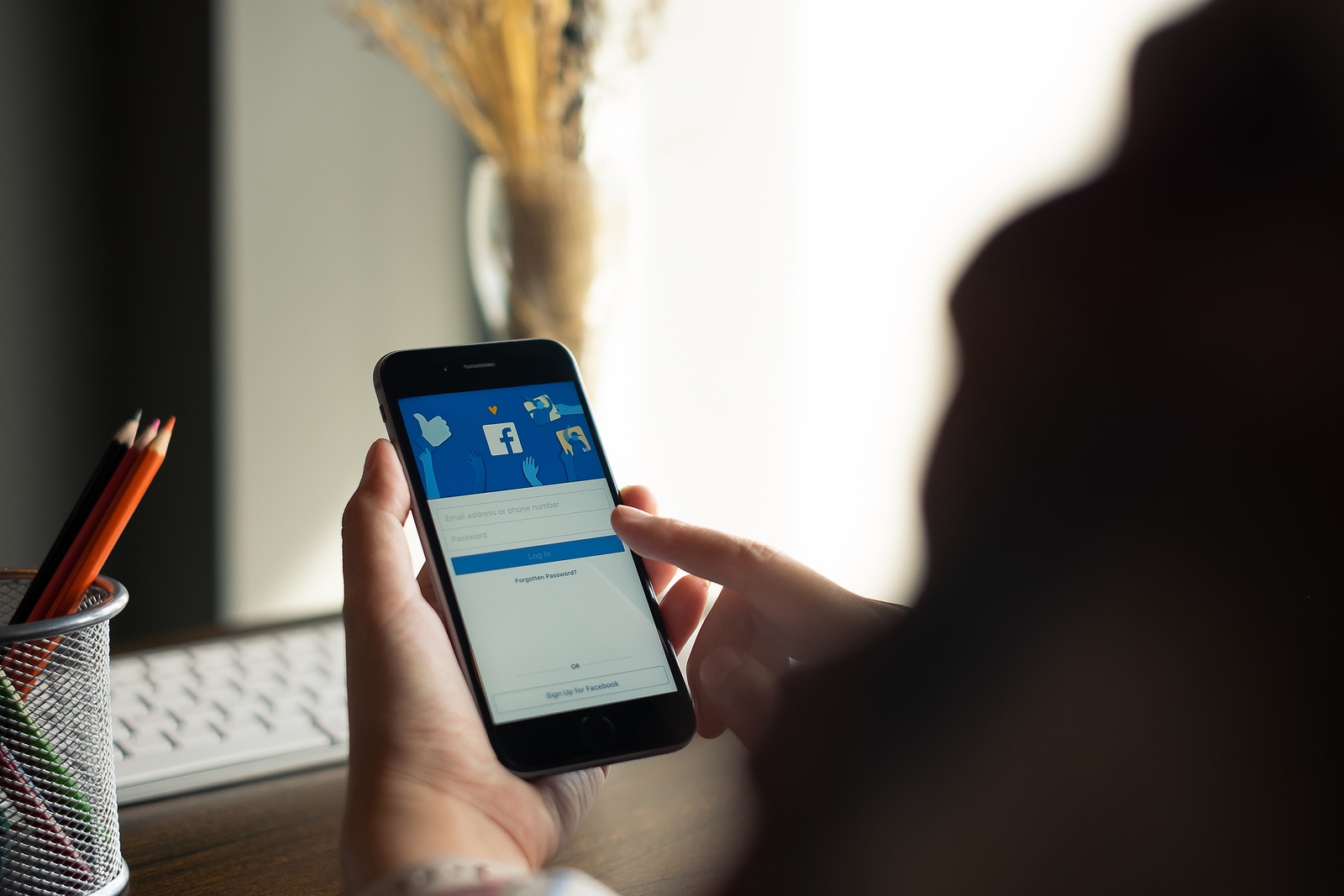 CHIANG MAI, THAILAND - AUG 15, 2018: iPhone with facebook application on the screen.facebook is a photo-sharing app for smartphones. Facebook is a social network.
