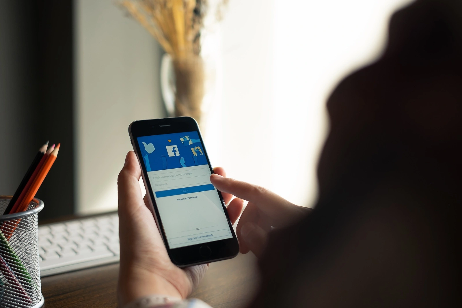 CHIANG MAI, THAILAND - AUG 15, 2018: iPhone with facebook application on the screen.facebook is a photo-sharing app for smartphones. Facebook is a social network.