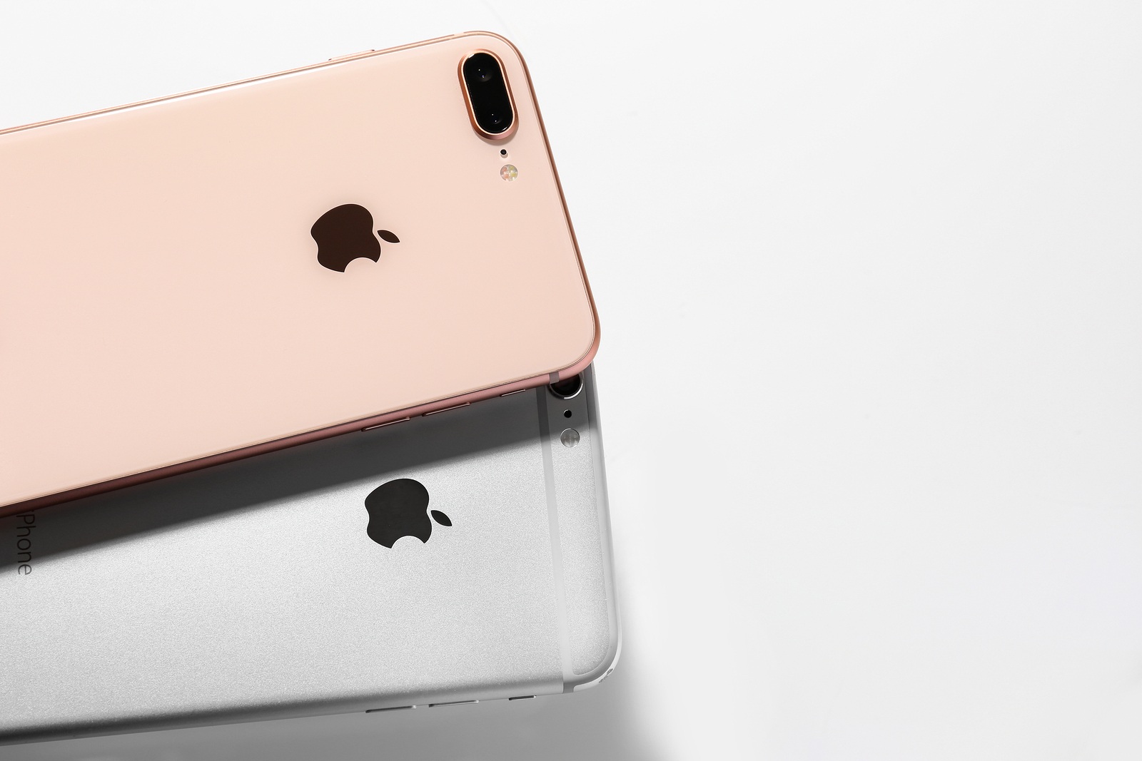 KIEV, UKRAINE - OCTOBER 23, 2017: Back panel of iPhone 8 Plus Gold and iPhone 6s Plus Silver on light background