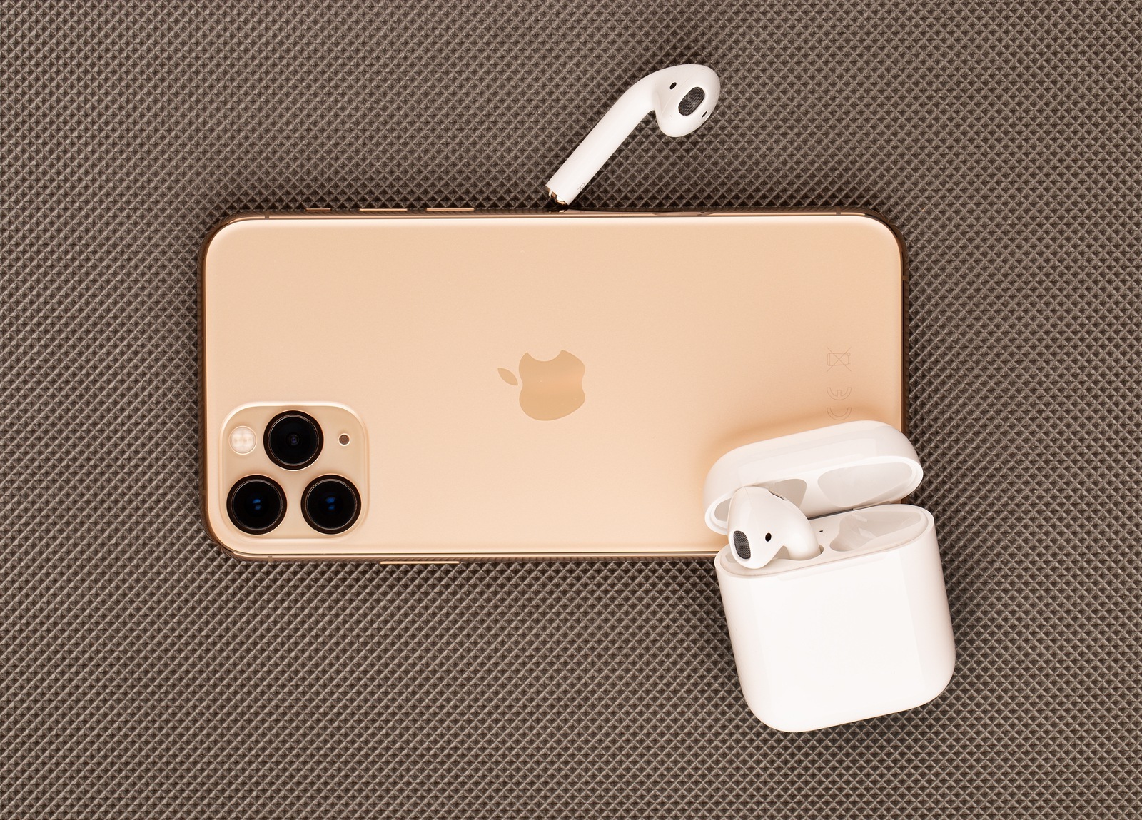 Rostov-on-Don, Russia - October 2019. Apple iPhone 11 Pro on a wooden surface. Apple's new smartphone close-up. Smartphone and AirPods headphones.
