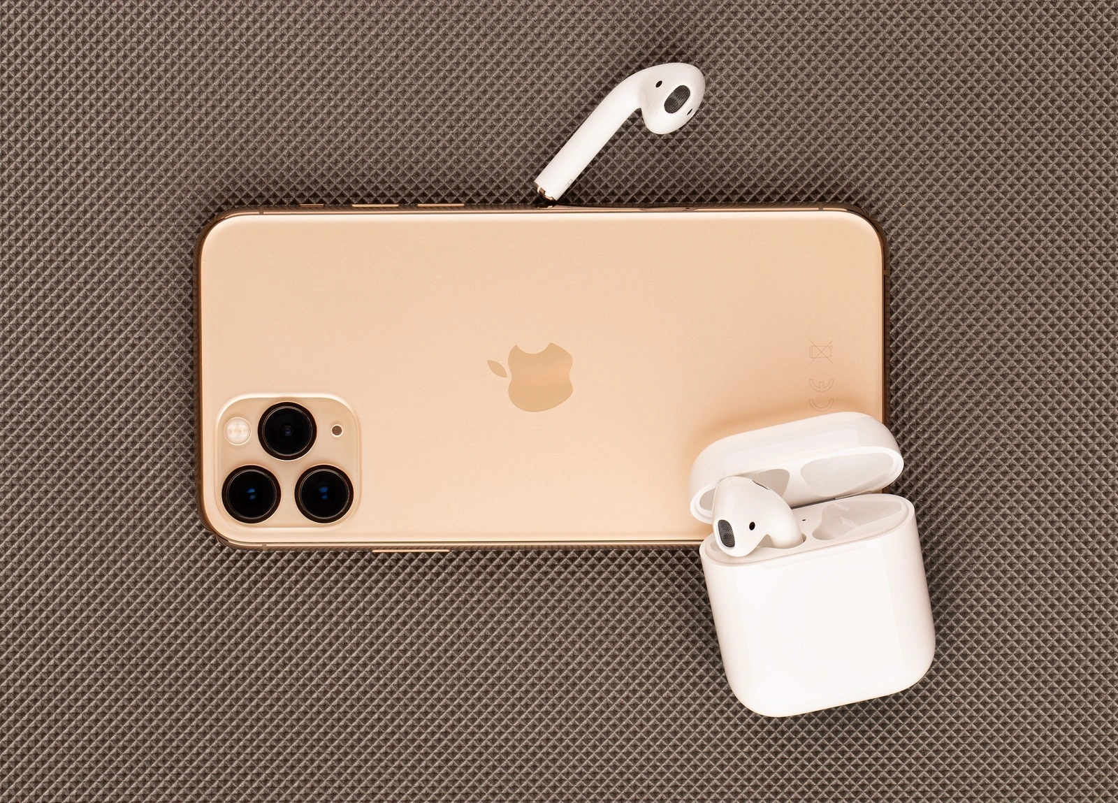 Rostov-on-Don, Russia - October 2019. Apple iPhone 11 Pro on a wooden surface. Apple's new smartphone close-up. Smartphone and AirPods headphones.