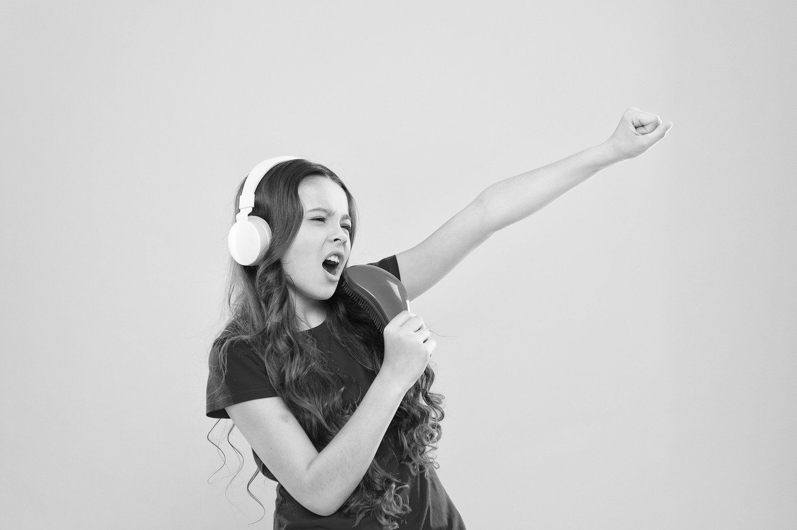 Sing lyrics. Little girl enjoying favorite music. Catch the rhythm. Kid listening music headphones. Entertainment and fun. Whole musical world in her ears. Child teen enjoys music playing in earphones.