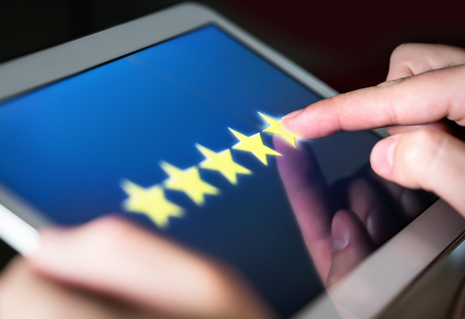 5 star rating or review in survey, poll, questionnaire or customer satisfaction research. Happy man giving positive feedback with tablet. Successful business with good reputation. Good experience.