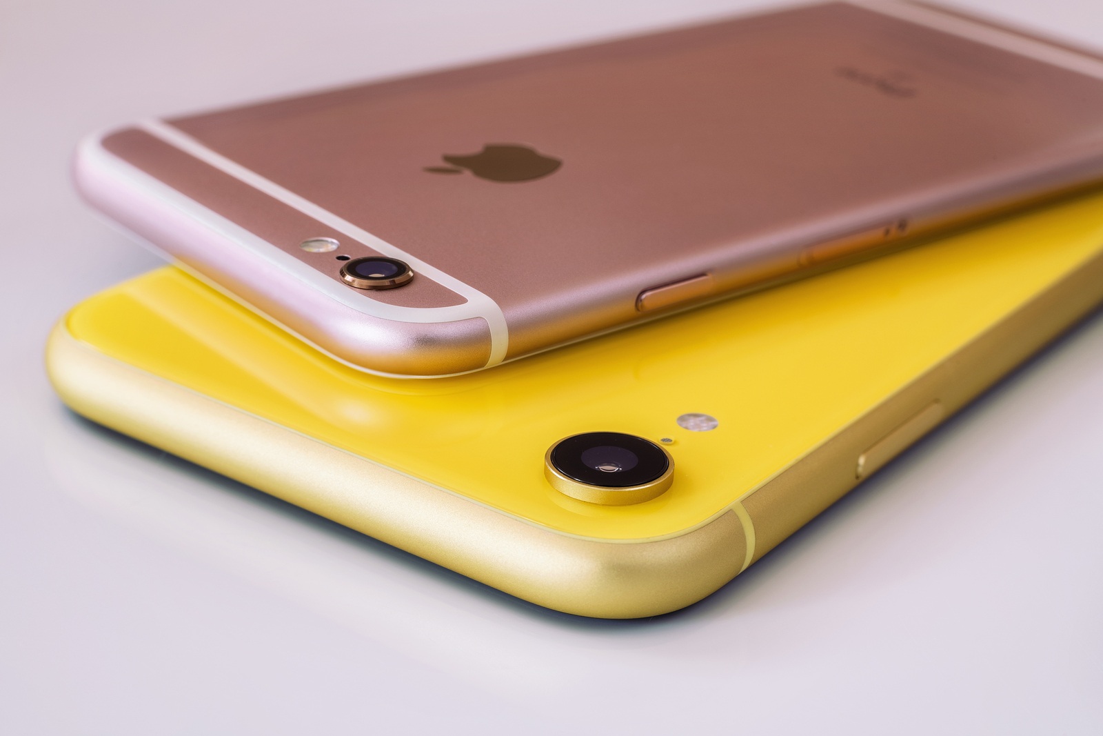 08/22/2019 Ukraine: Closeup yellow iphone xr and pink iphone 6s on isolated background