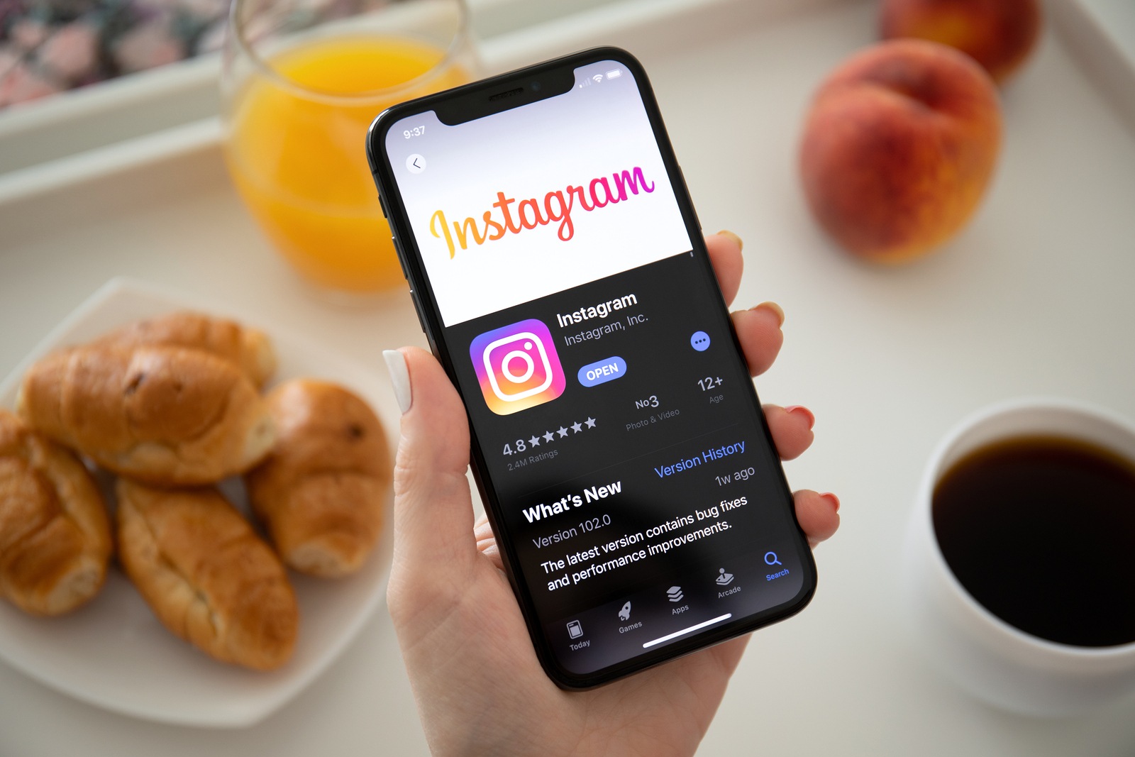 Anapa, Russia - July 23, 2019: Woman hand holding iPhone X with social networking service Instagram on the screen. iPhone was created and developed by the Apple inc.