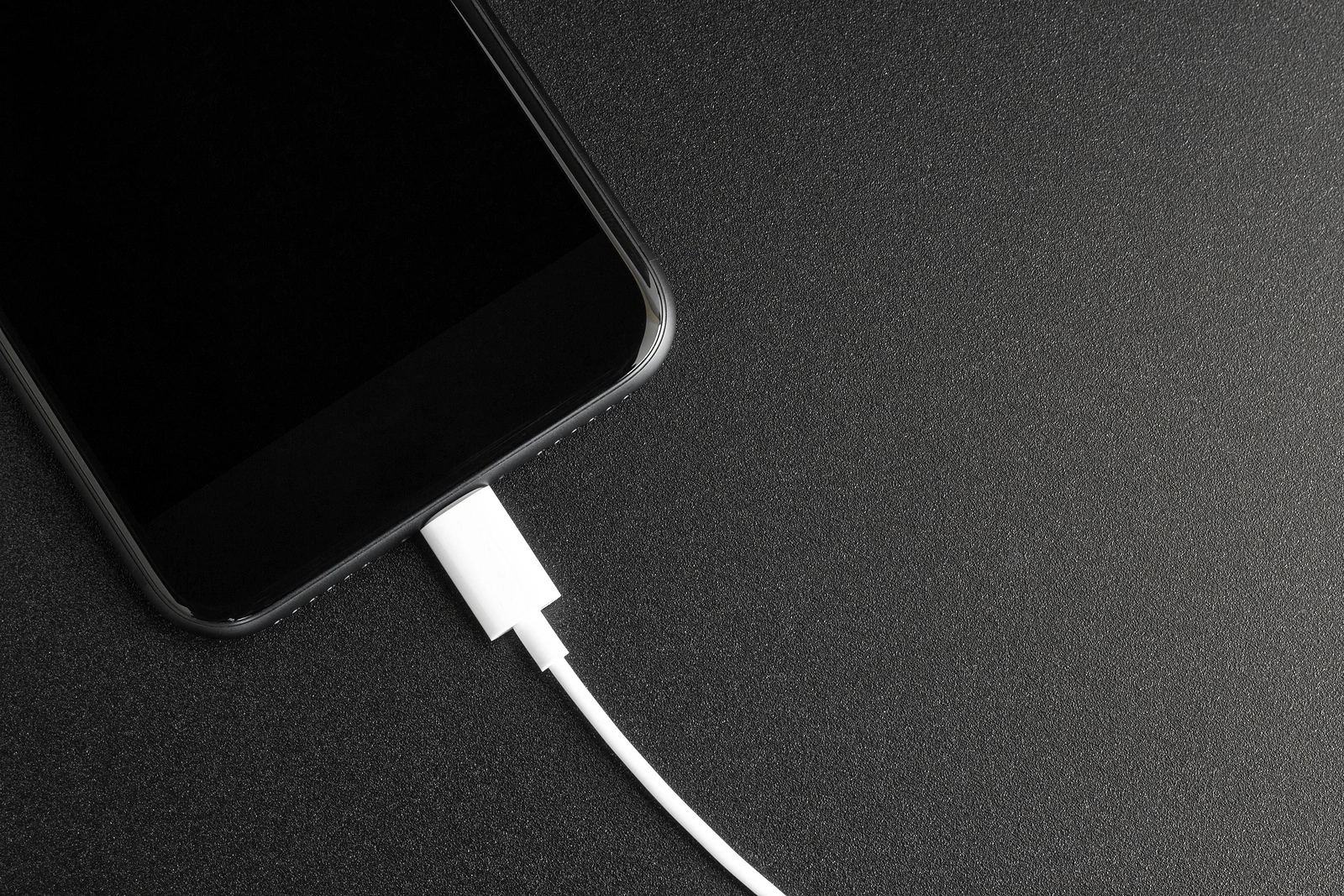 phone connecting usb port on black background top view
