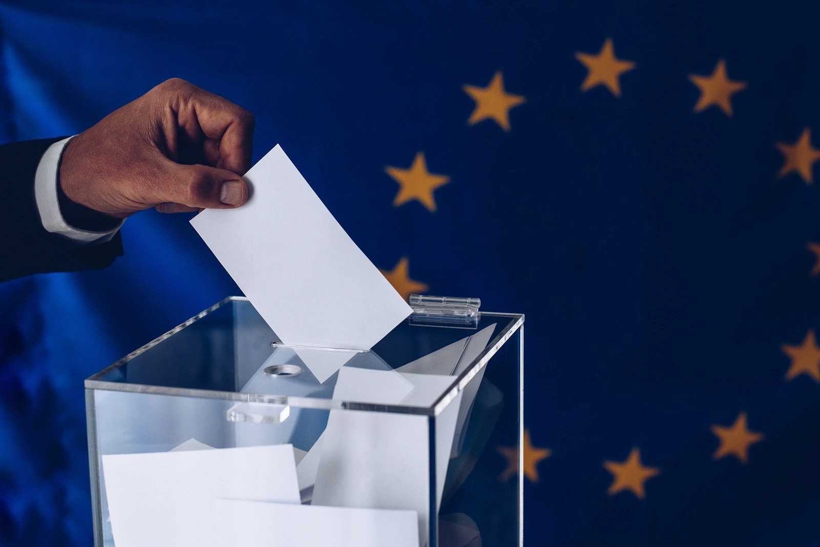 Elections to the European Parliament. EU elections. Man throwing his vote into the ballot box.