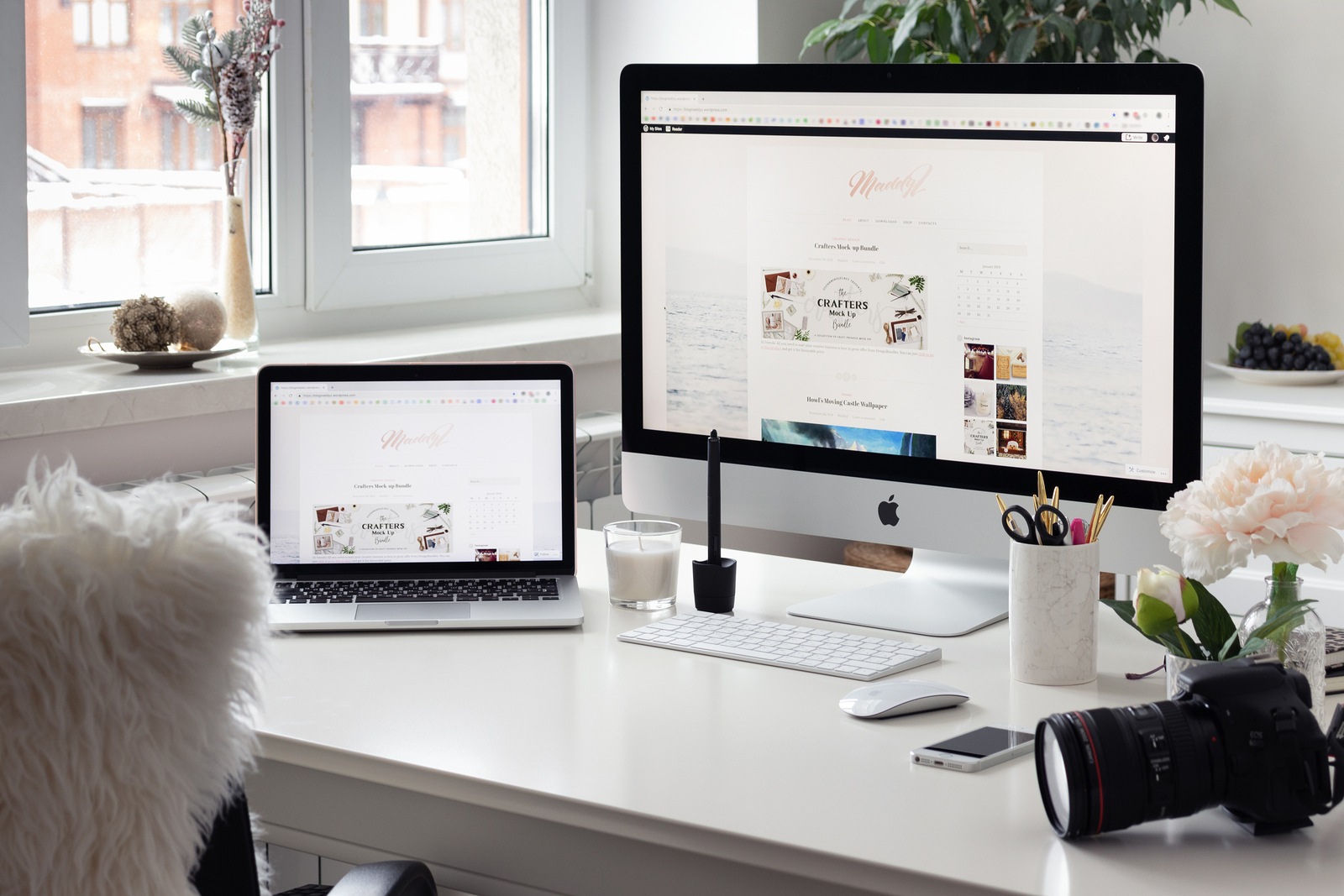 Moscow, Russia - January, 7 2018. Stylish cozy workspace with Imac and Macbook, graphic designers and photographers home studio