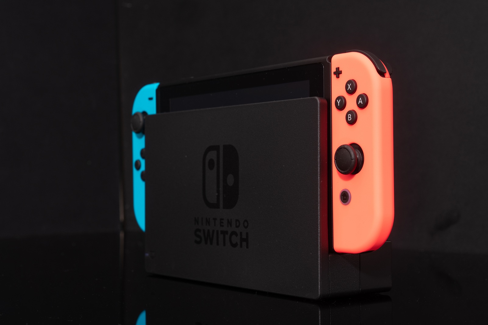 Nintendo Switch video game console developed by Nintendo, released on March 3, 2017 on a black background. Germany, Berlin - June 30, 2019: Nintendo Switch Joy-con controller on a white background