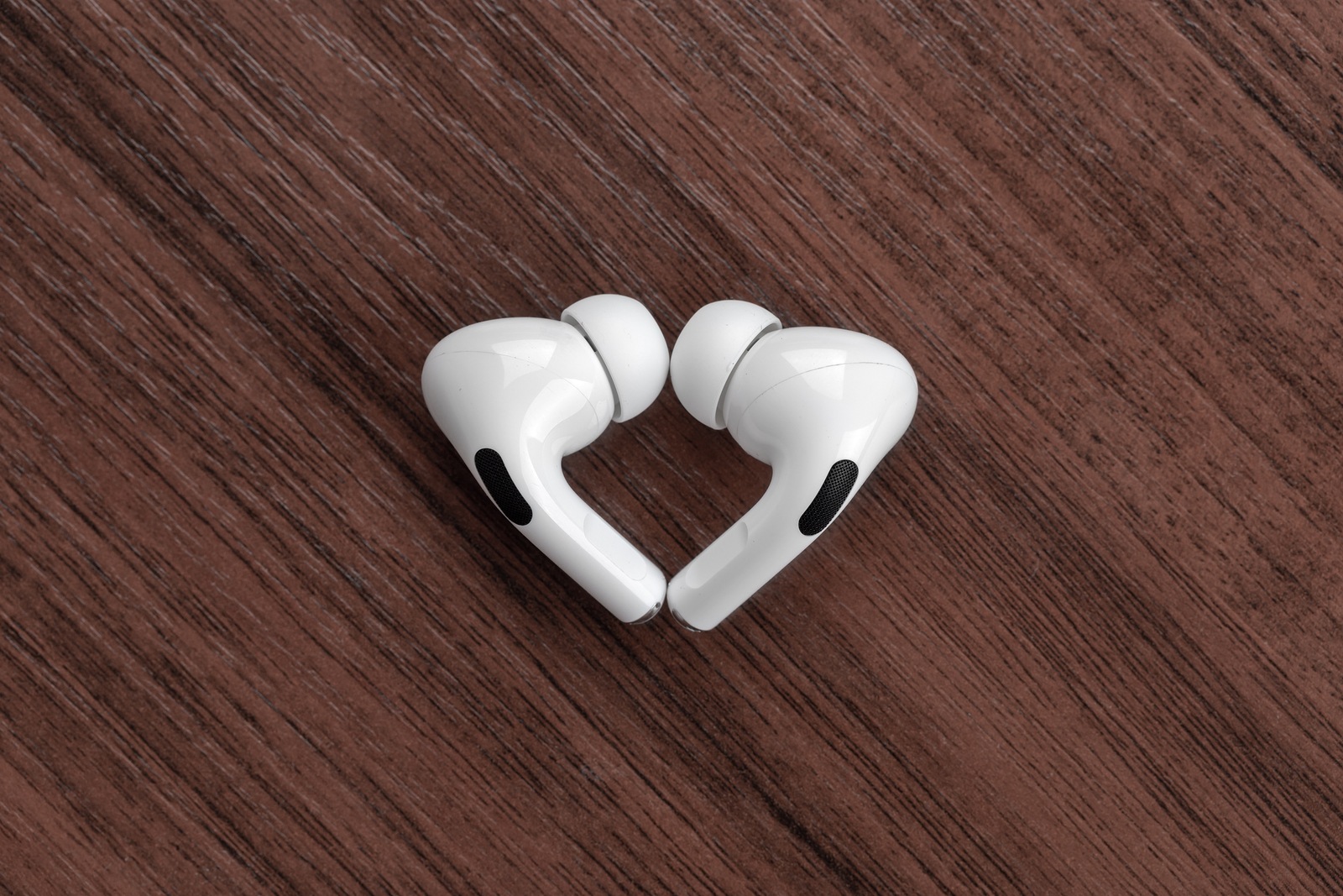 Rostov-on-Don, Russia - December 2019. Apple AirPods Pro on a wooden table. Wireless headphones close-up.