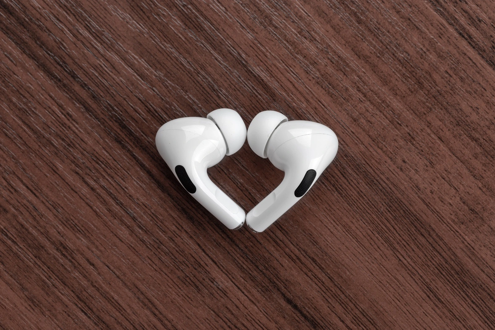 Rostov-on-Don, Russia - December 2019. Apple AirPods Pro on a wooden table. Wireless headphones close-up.
