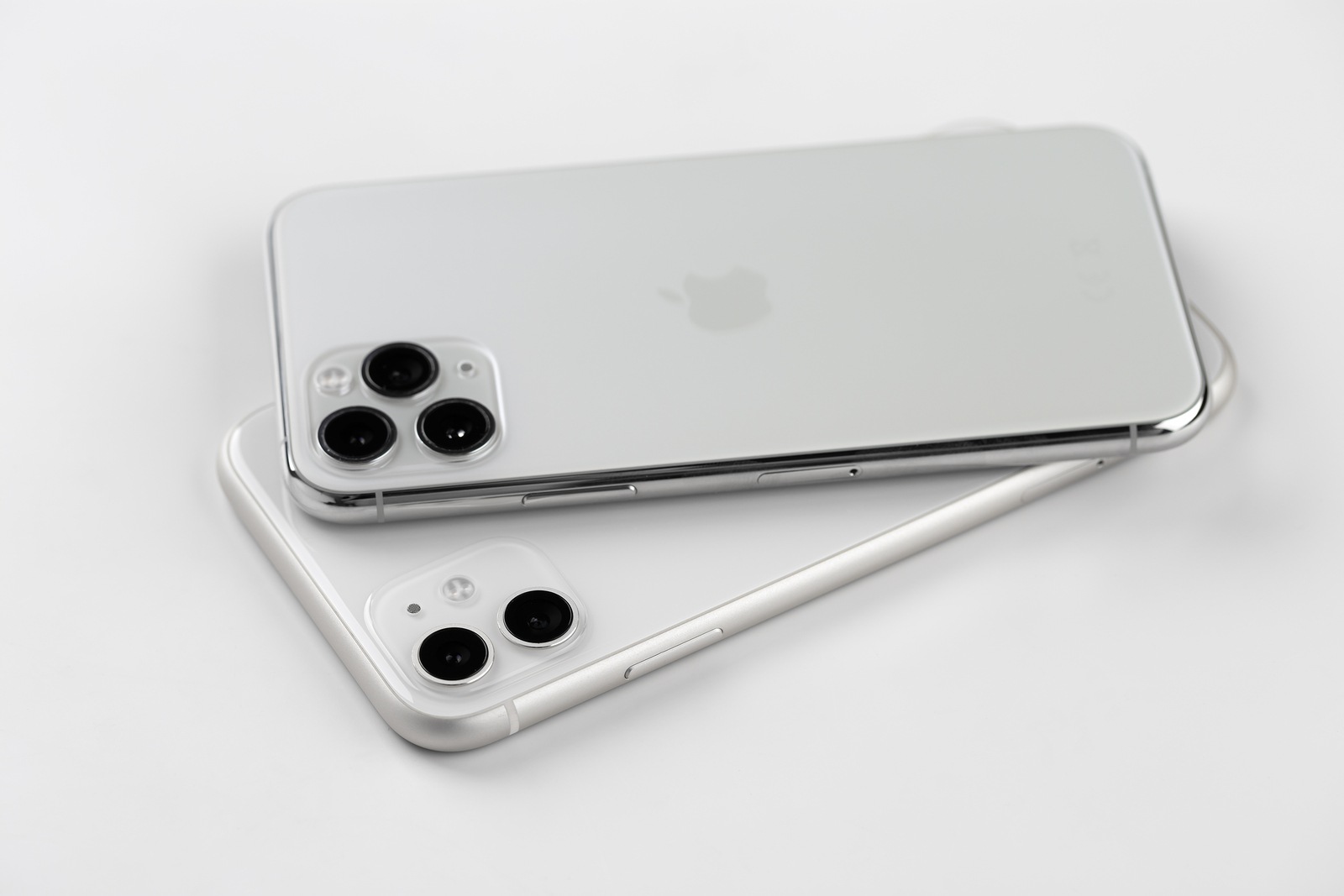 Rostov-on-Don, Russia - November 2019. Apple iPhone 11 and Apple iPhone 1 Pro silver color on a white background. New smartphones from the company Apple close-up.