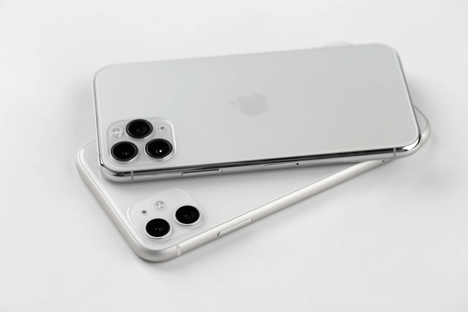 Rostov-on-Don, Russia - November 2019. Apple iPhone 11 and Apple iPhone 1 Pro silver color on a white background. New smartphones from the company Apple close-up.