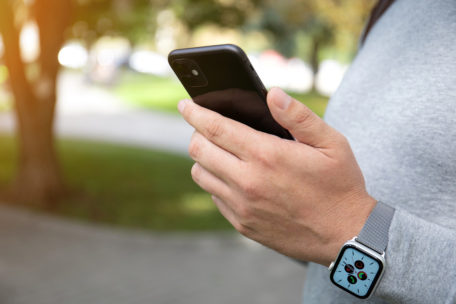 Anapa, Russia - September 26, 2019: Man hand with Apple Watch Series 5 holding iPhone 11. iPhone and Apple Watch was created and developed by the Apple inc.