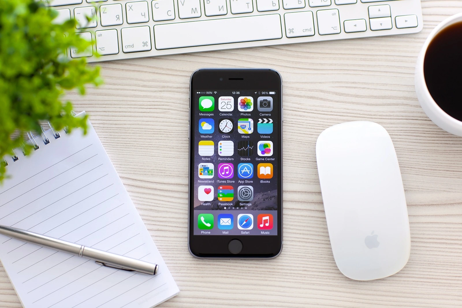 Alushta Russia - October 25 2014: New phone iPhone 6 Space Gray with apps on screen lies on the table. iPhone 6 was created and developed by the Apple inc.