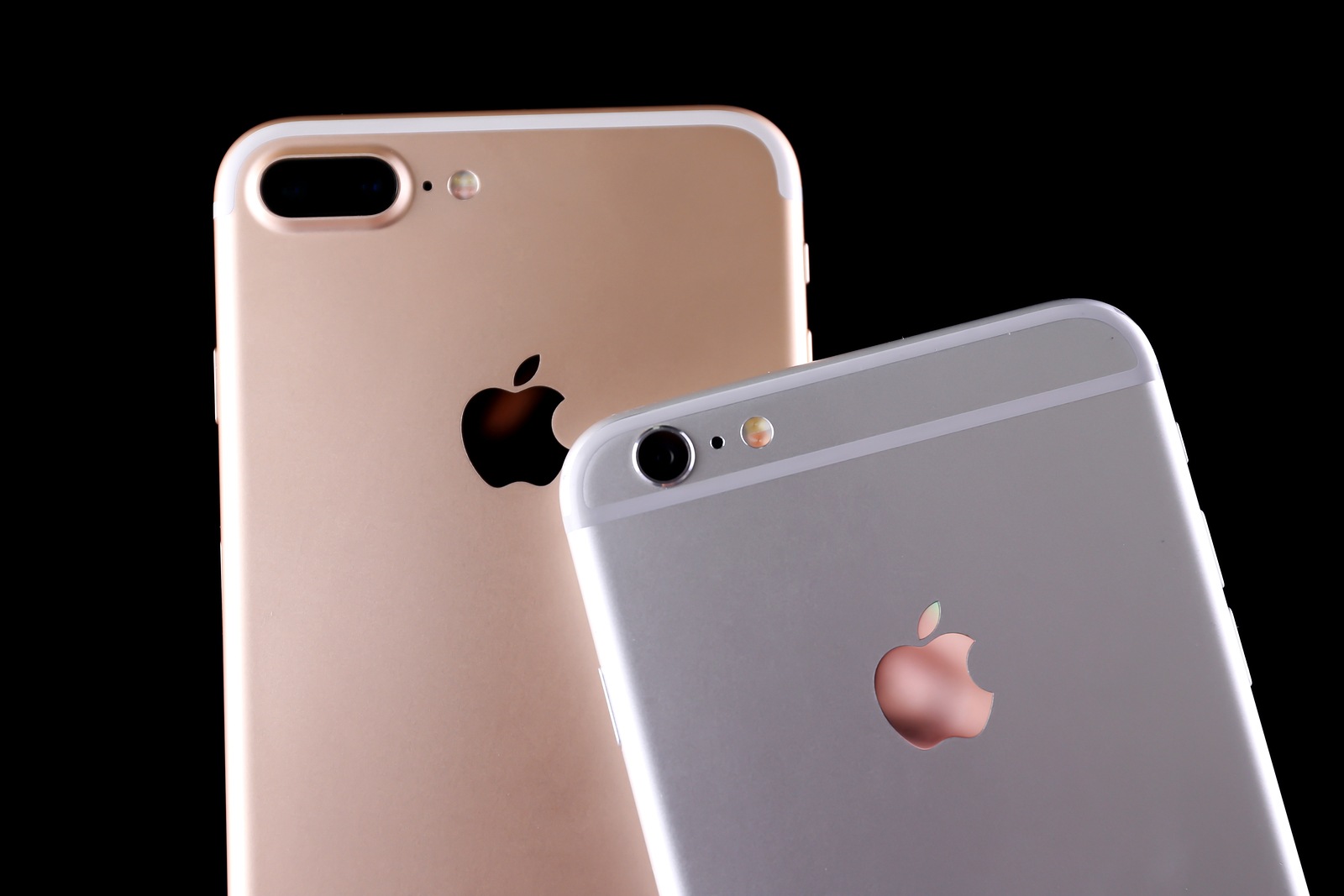 KIEV, UKRAINE - OCTOBER 19, 2017: Back panels of iPhone 7 Plus Gold and iPhone 6s Plus Silver on black background