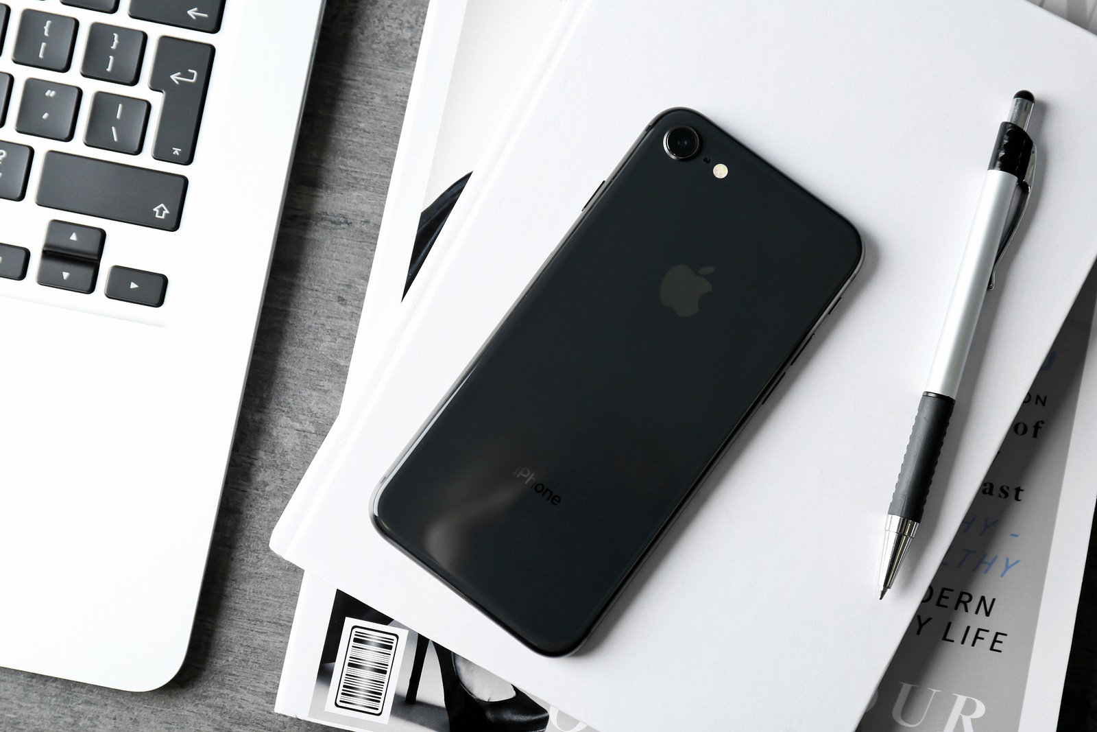 KYIV, UKRAINE - DECEMBER 5, 2017: Back panel of iPhone 8 Space Gray on notebook